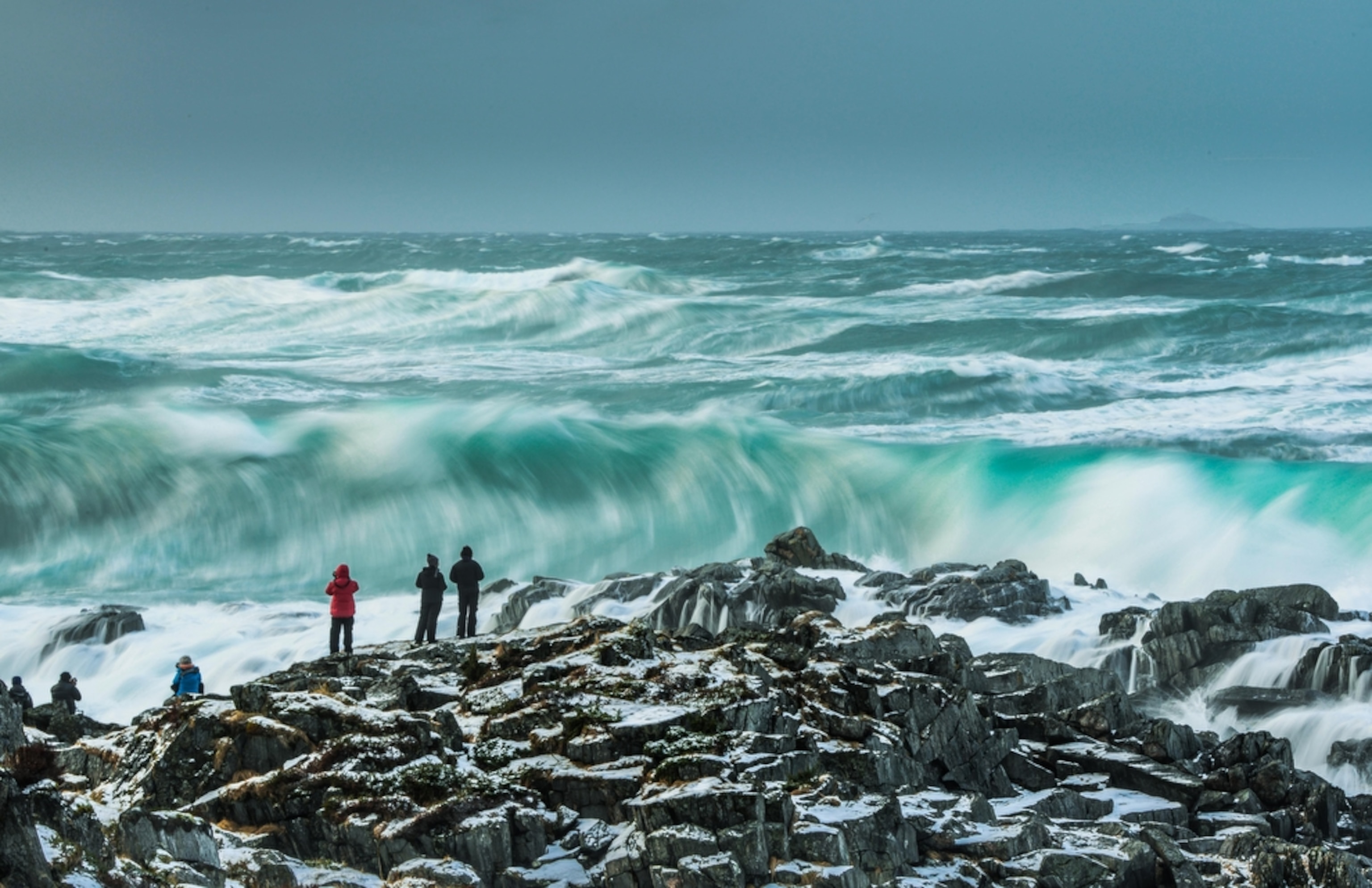 photographers with waves during an Arctic storm in Norway