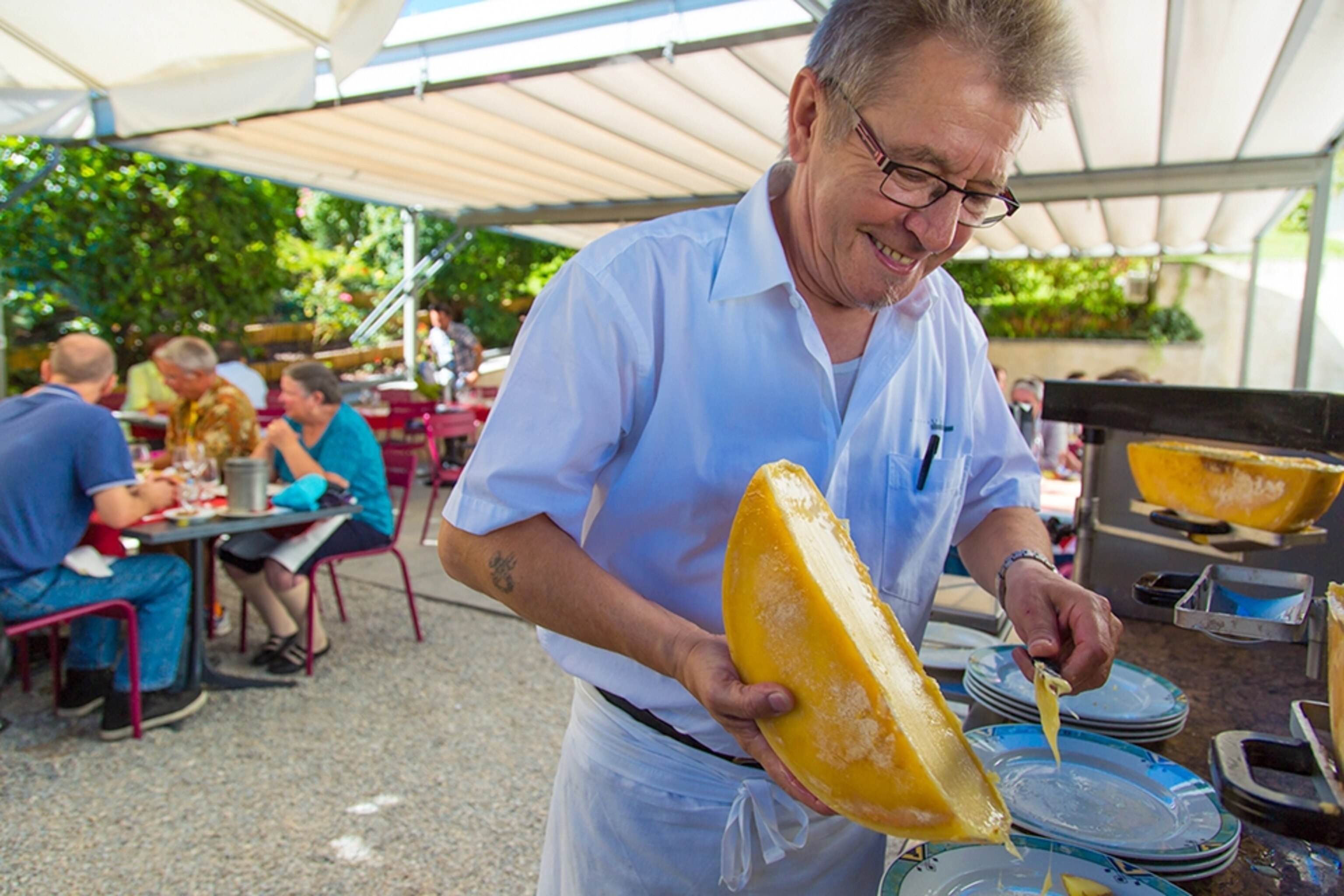 a man preparing raclette at the Chateau de Villa in Sierre, Switzerland