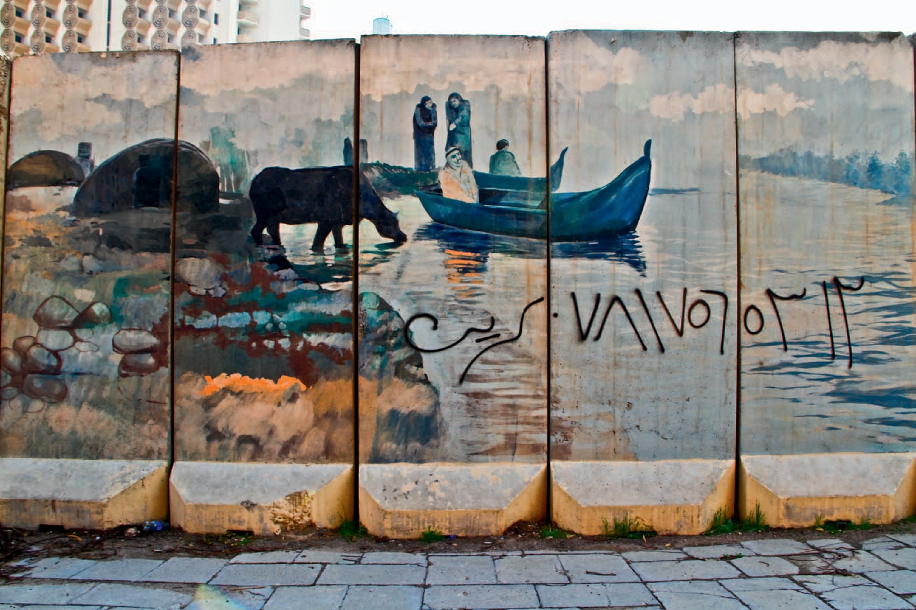 Art of Iraq - Wall with painting of a man in a boat.