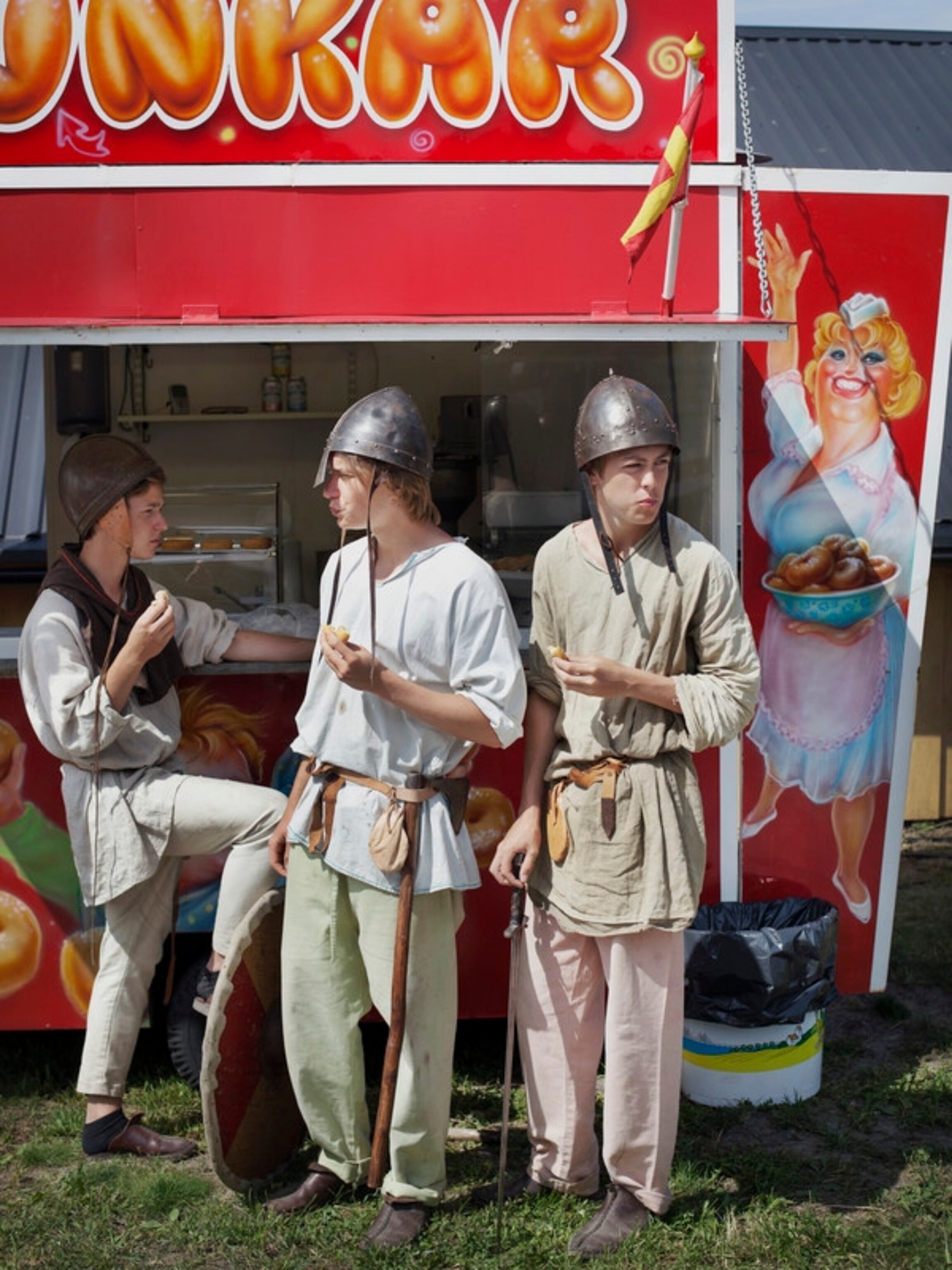 Three boys from the neighborhood are having their free period during the summer job at the viking festival near Höllviken. The Donats caravan that stands just outside the viking village is perfect hangout place for youngsters.