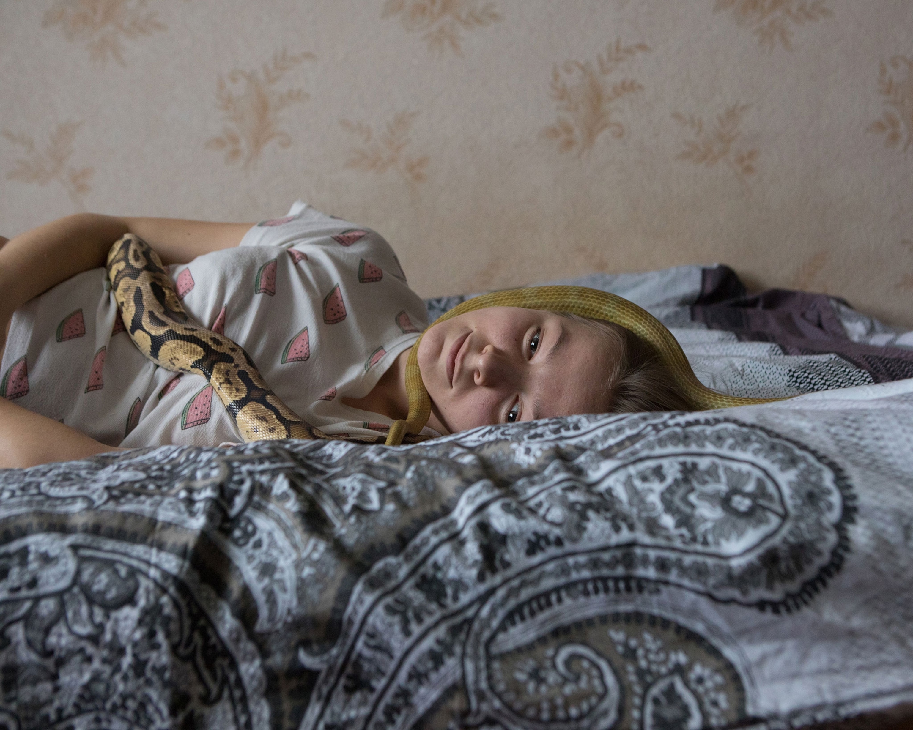 Elizaveta Lavrienko with a Python regius and Pantherophis guttatus