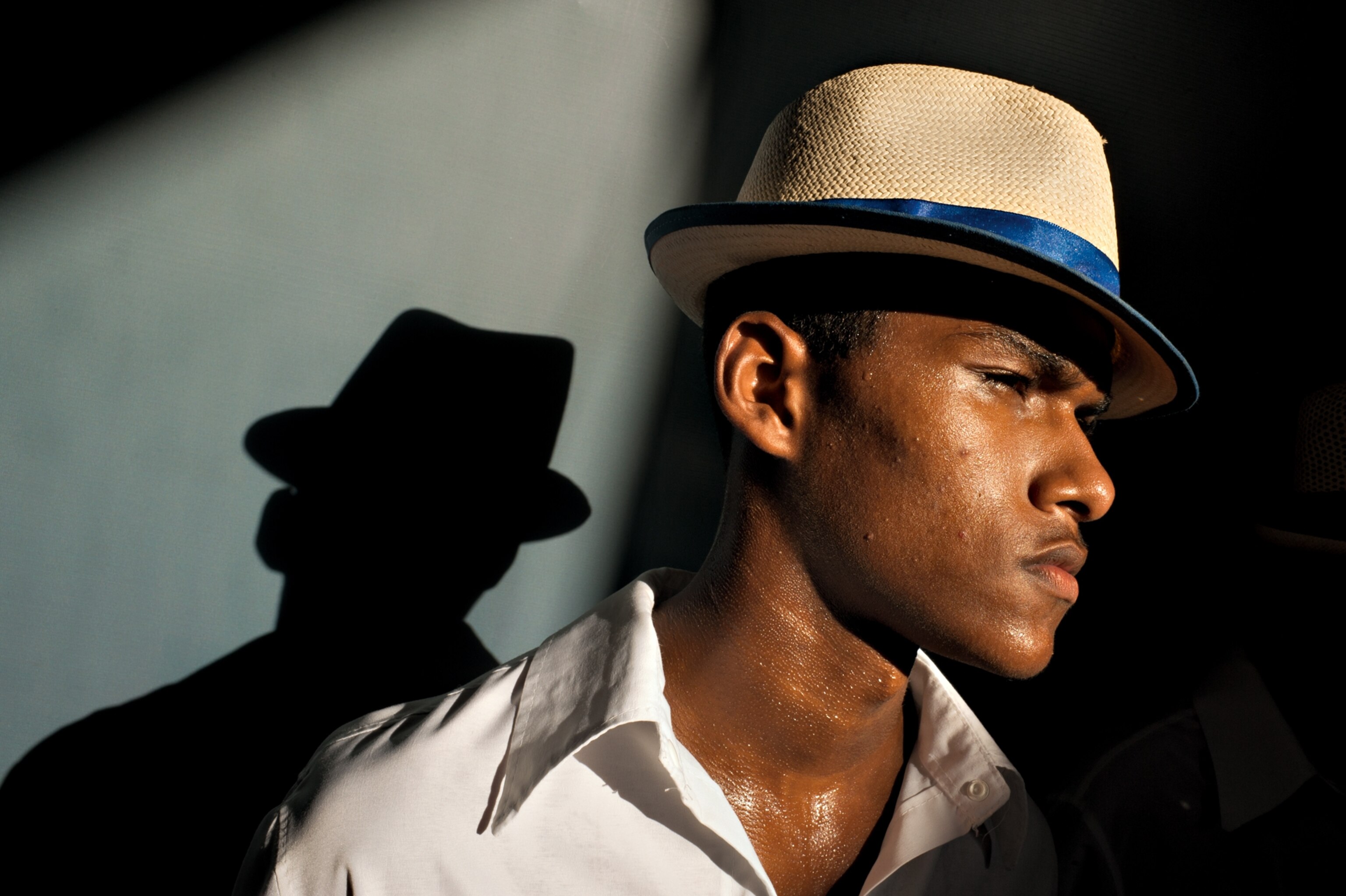 a Carnival dancer wearing white and blue to represent his samba school's colors