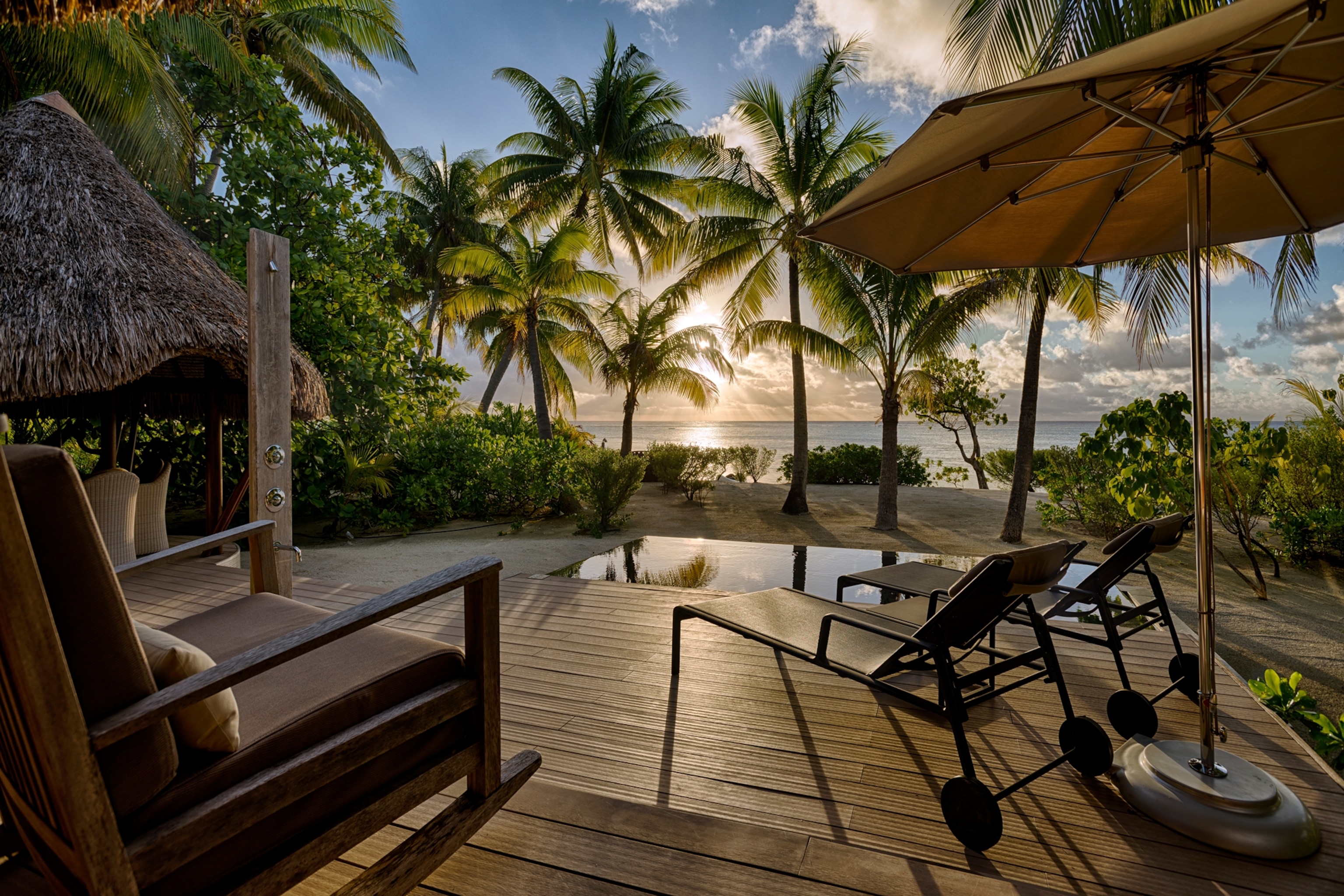 Villa deck view featuring a private beach area and plunge pool for guests to enjoy.
