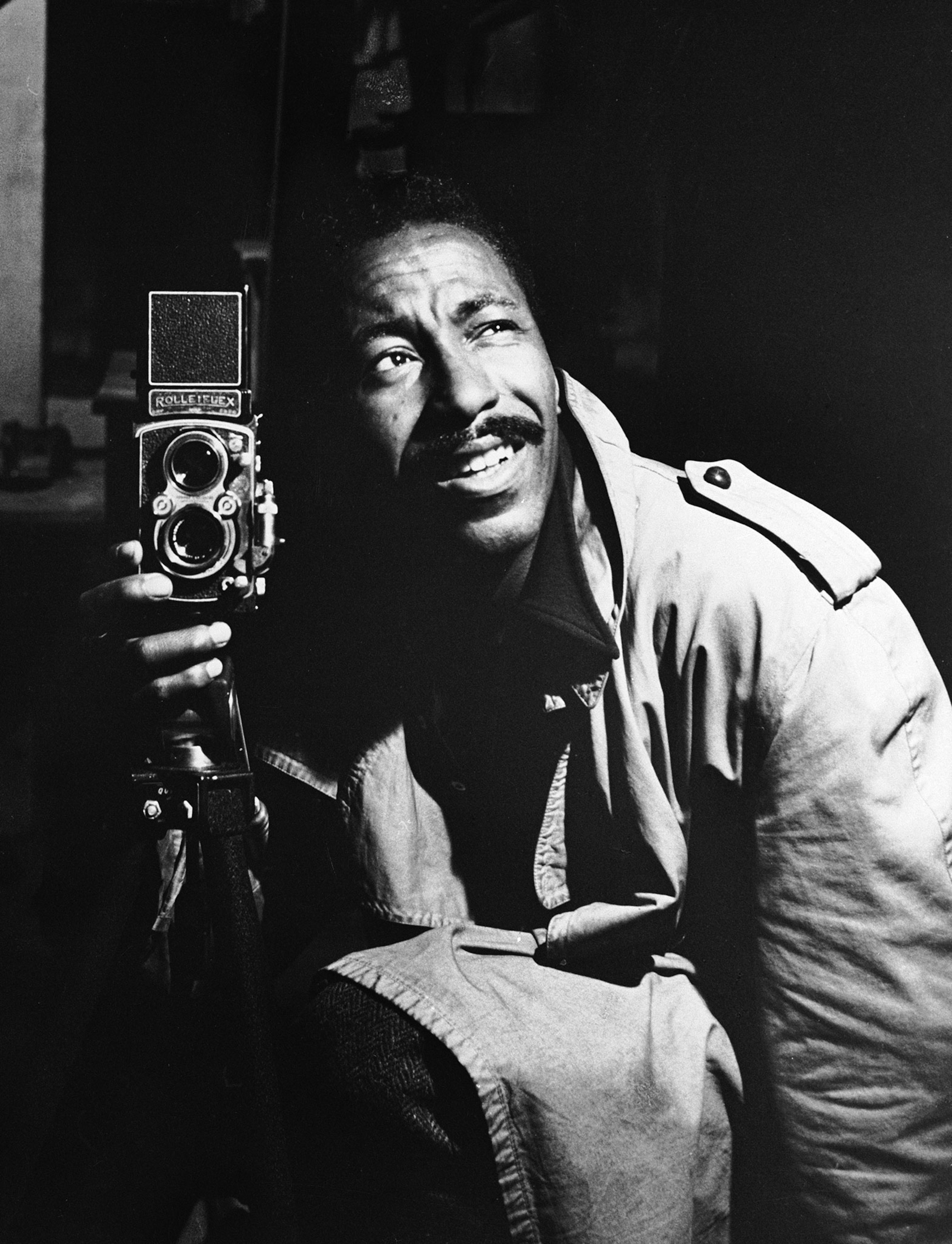 a man holding a camera and looking up