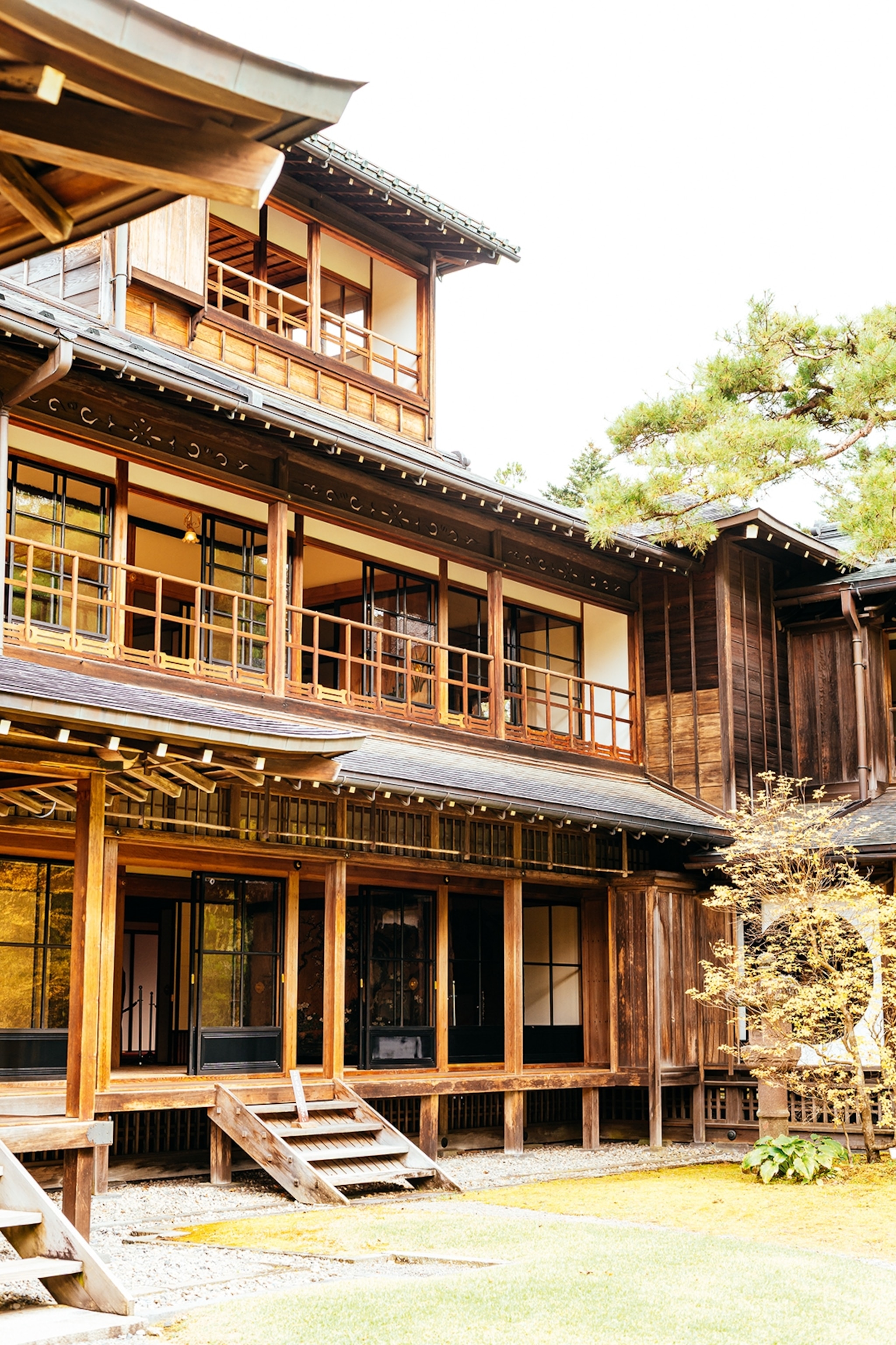 An ancient wooden shrine in Japan surrounded by trees.