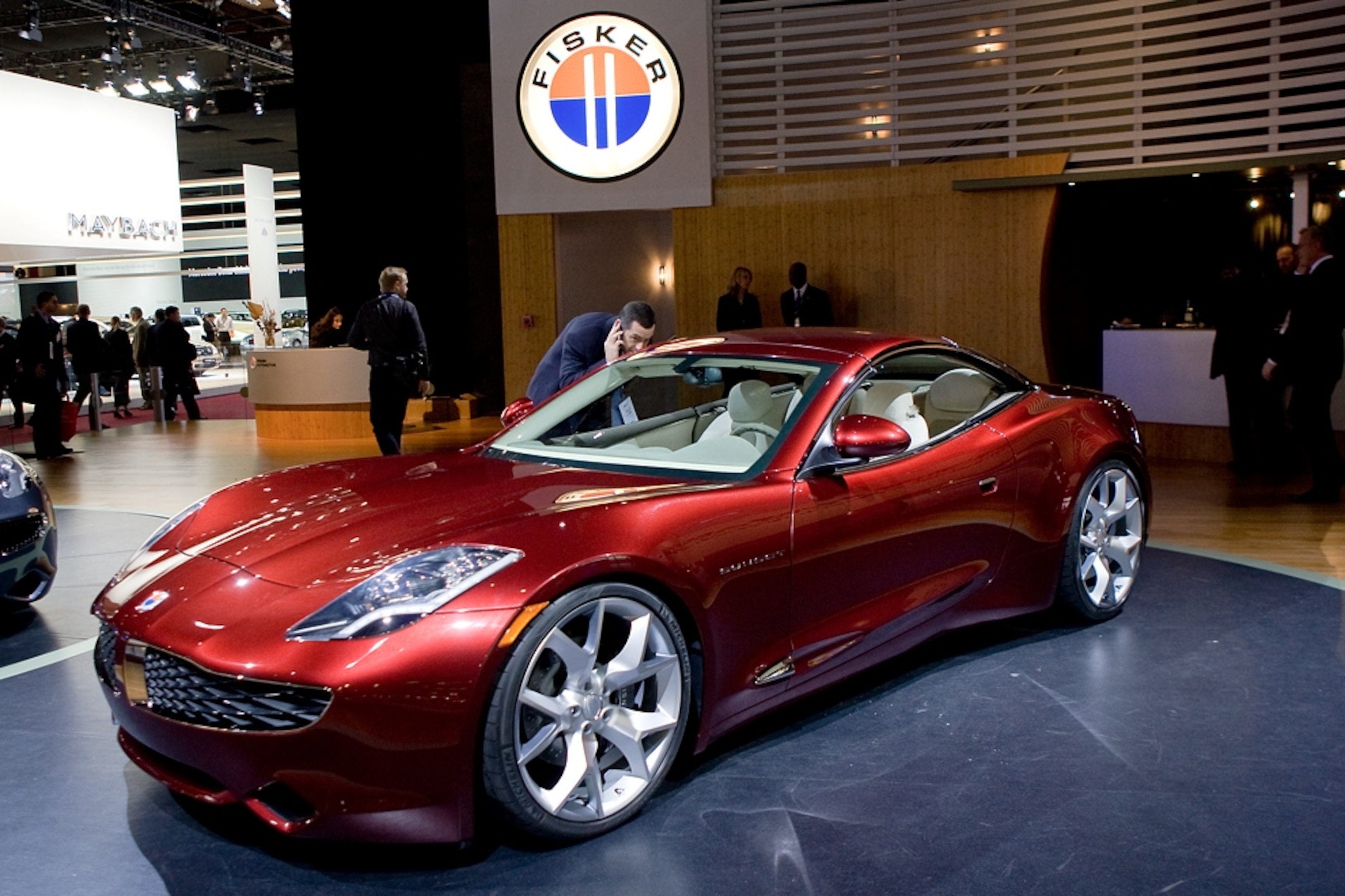 A red Fisker Karma on display at an auto show