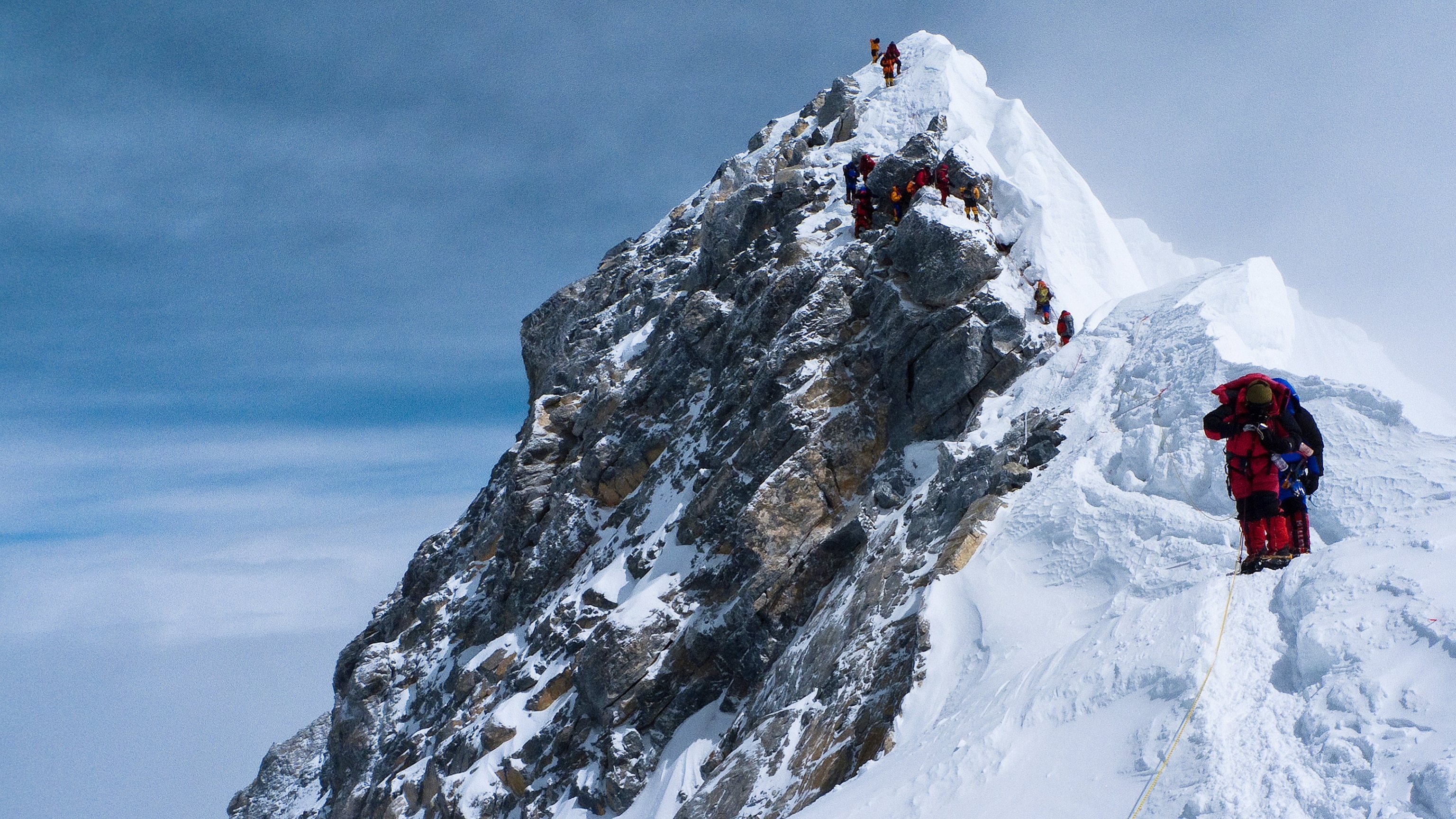 climbers descending the Hillary Step on Mount Everest