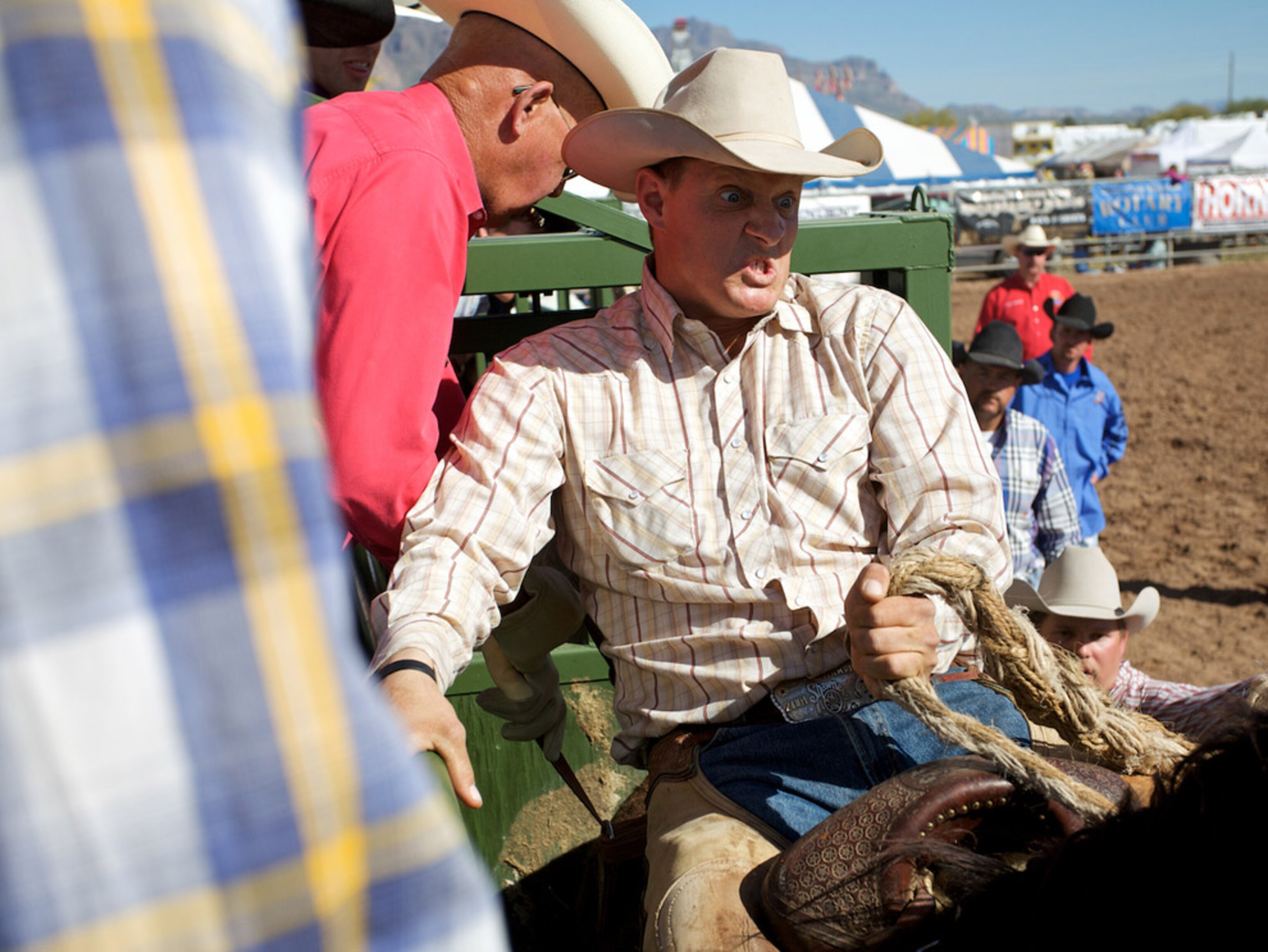 A man grimacing on a horse