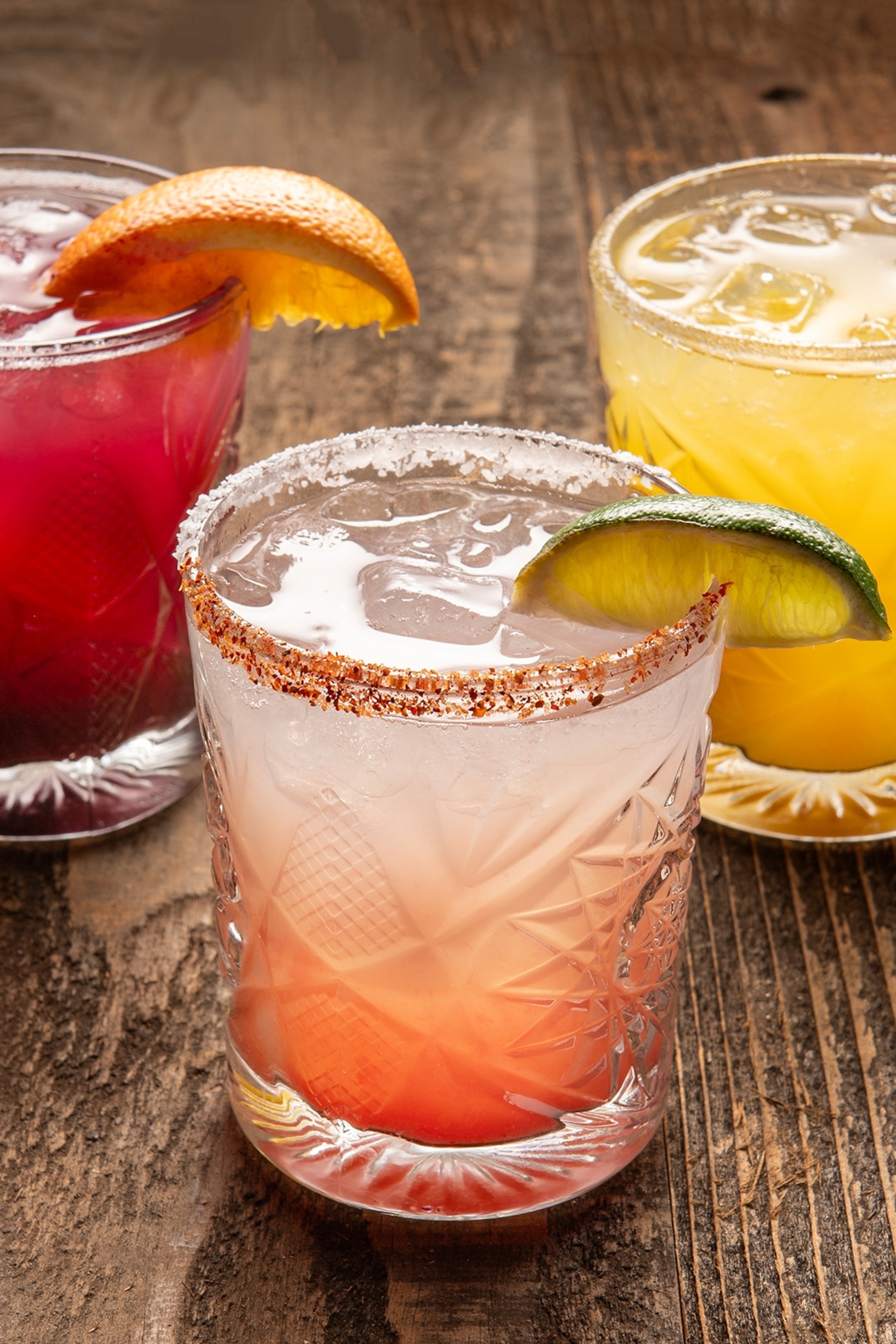 Close up of three colourful margarita cocktails.