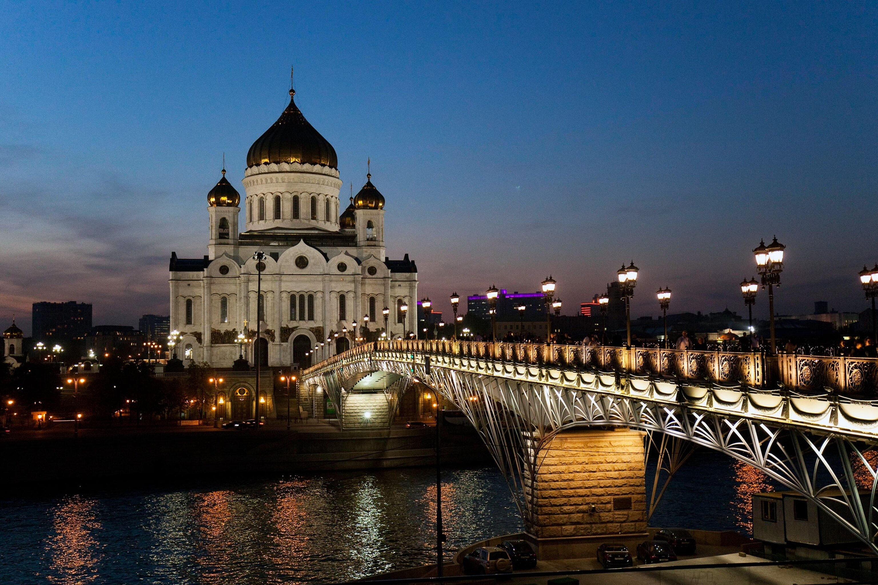 The Russian Orthodox Church, outlawed during Soviet times, has returned to importance as part of every day life for Russians. Here, the newly-built Cathedral of Jesus Christ Our Saviors rises above the Moscow bridge. Photograph by Ryan Bell.