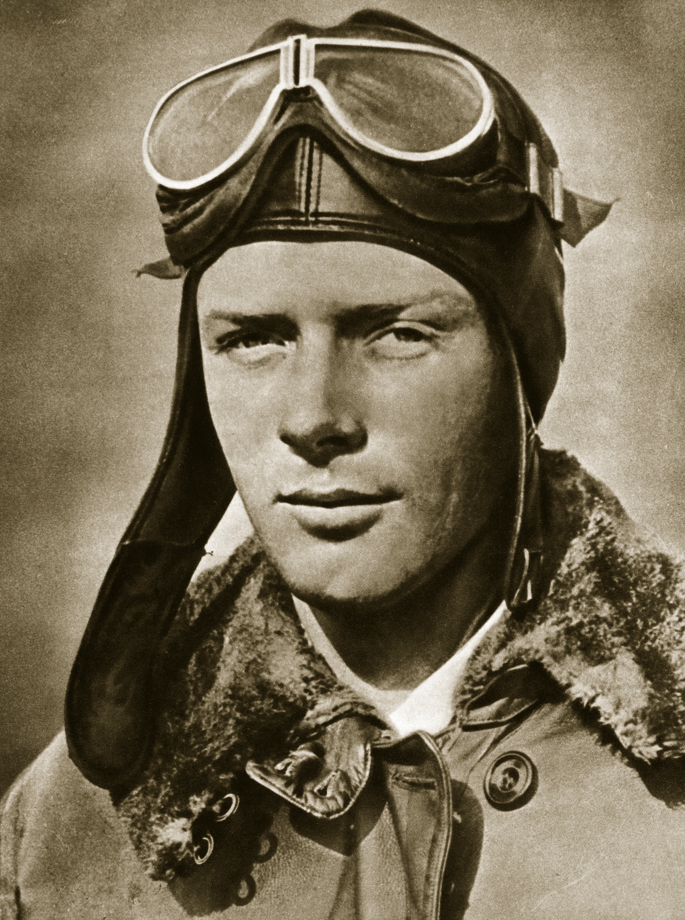 Headshot portrait of Charles Lindbergh wearing a hat and goggles