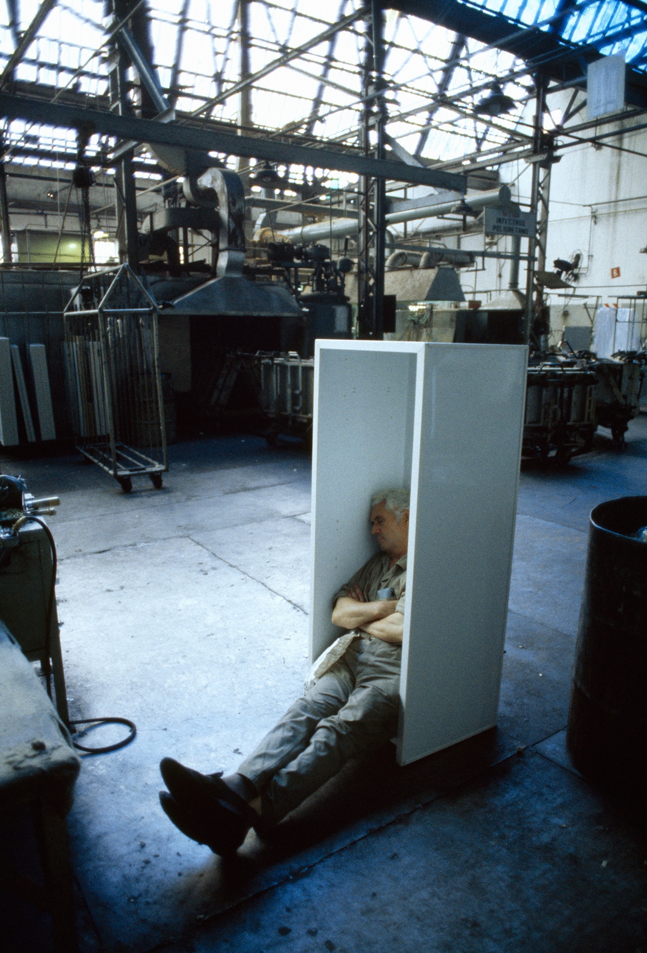 man napping in unfinished refrigerator
