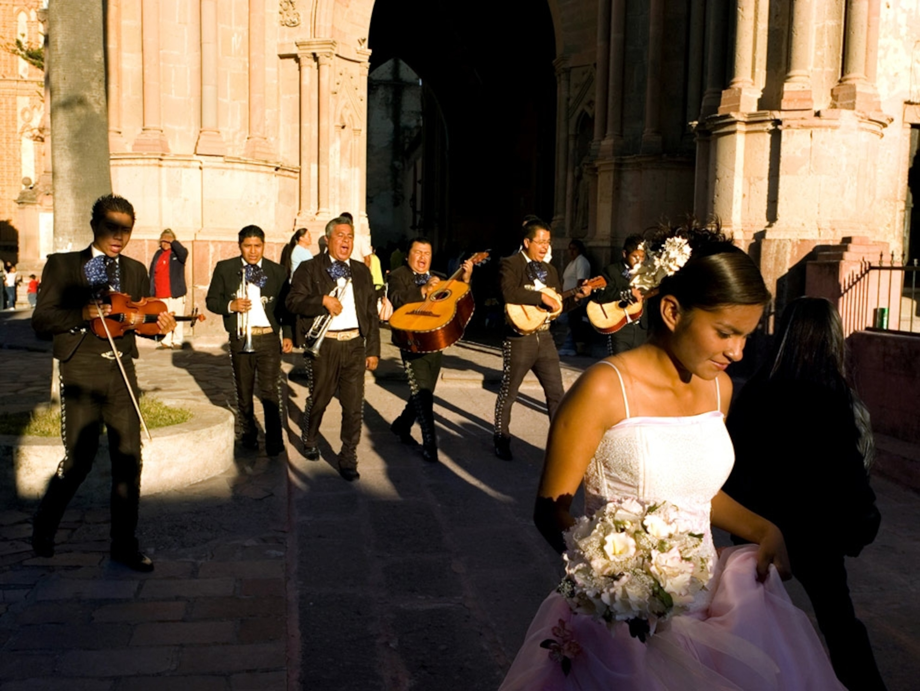 A girl and a band in front of a church