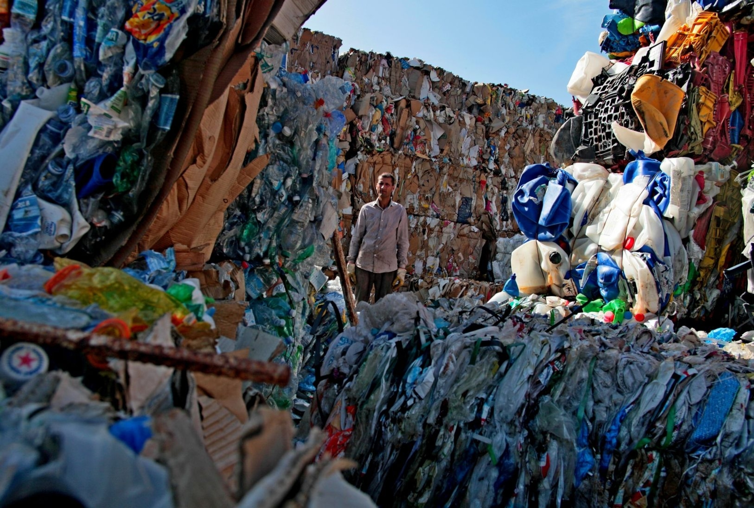 man in maze of trash mountains