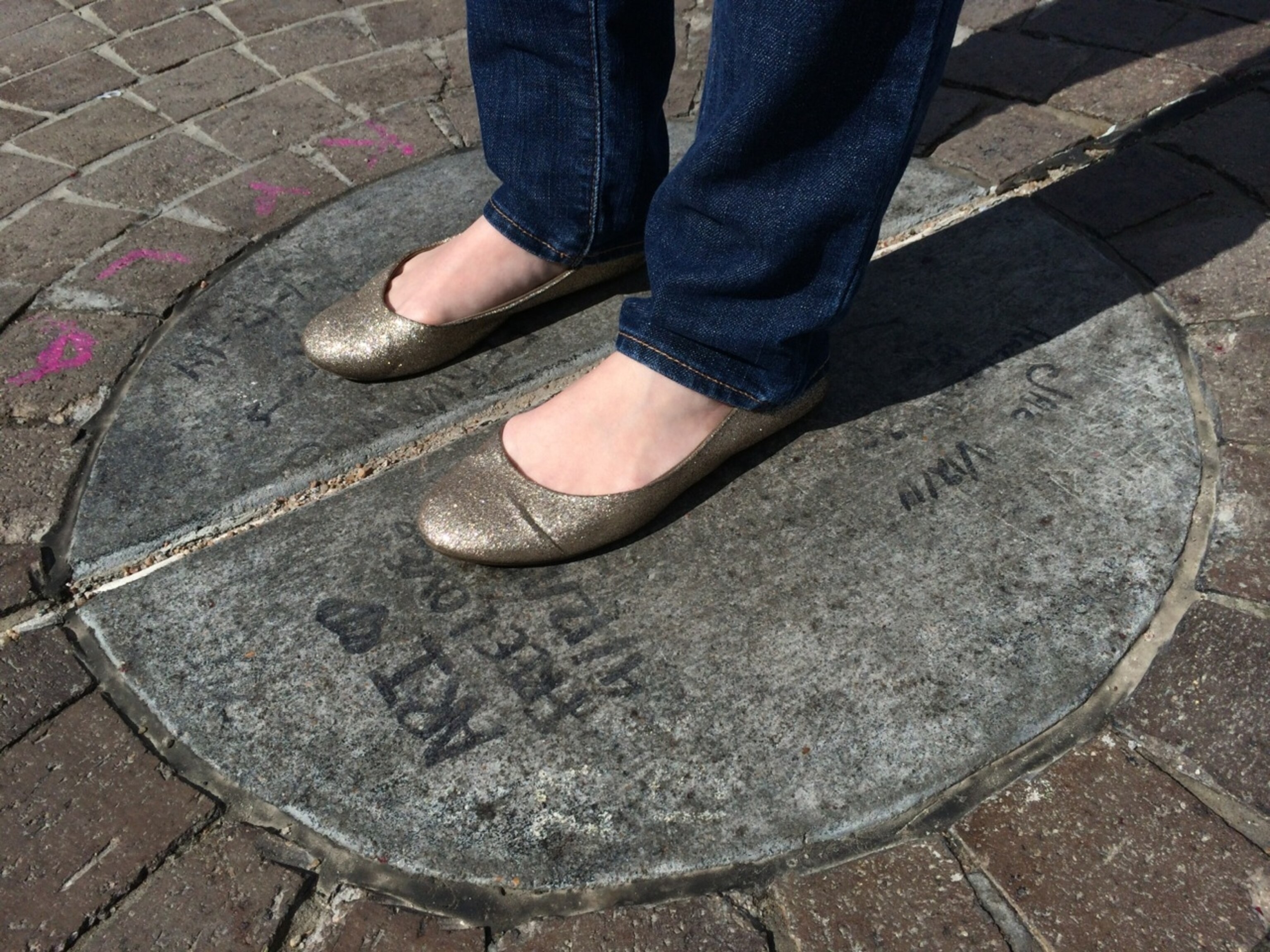 Andrea steps on the Center of the Universe in Tulsa, Oklahoma. (Photo by Andrew Evans, National Geographic Travel)