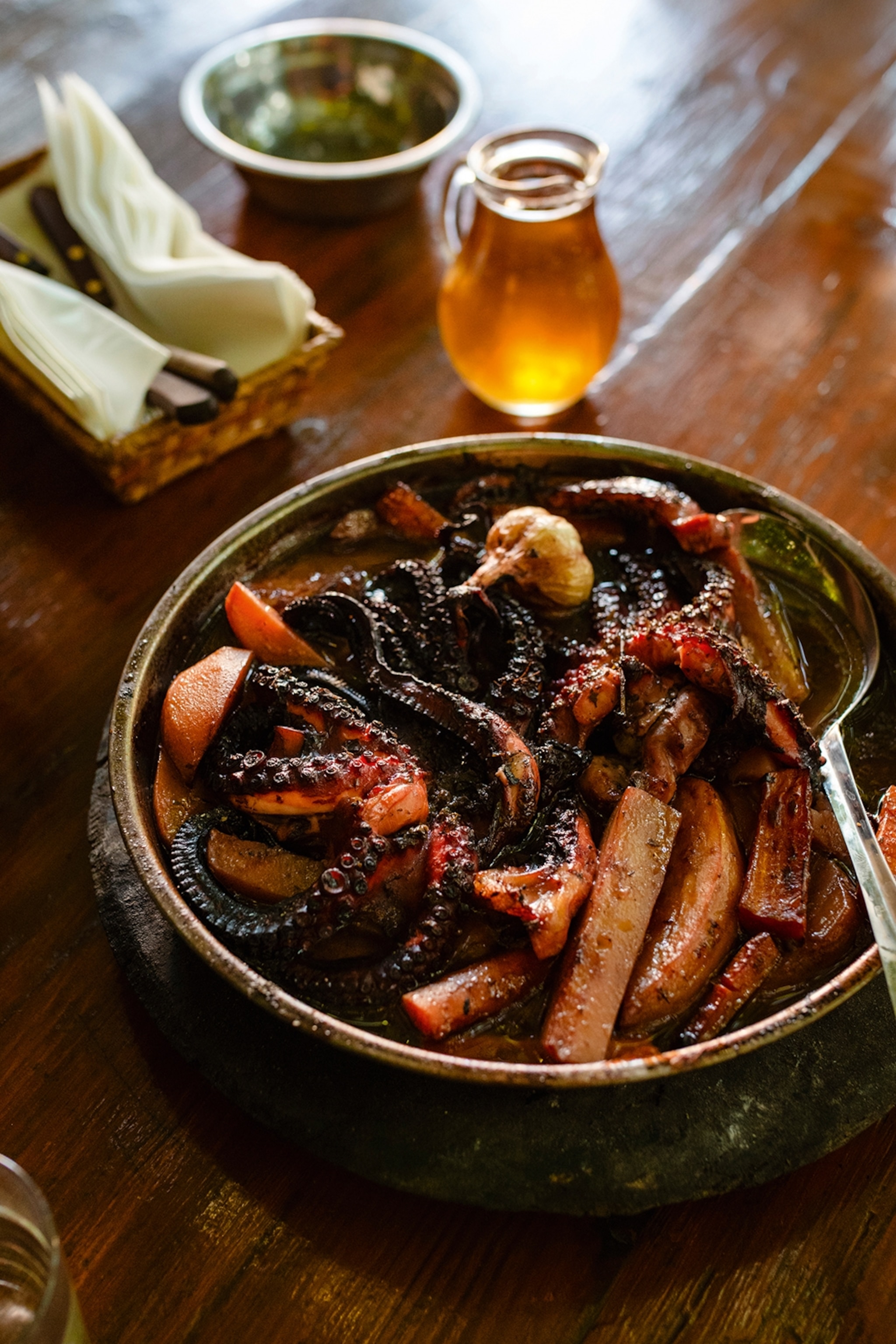 A close-up of a roasted octopus dish.