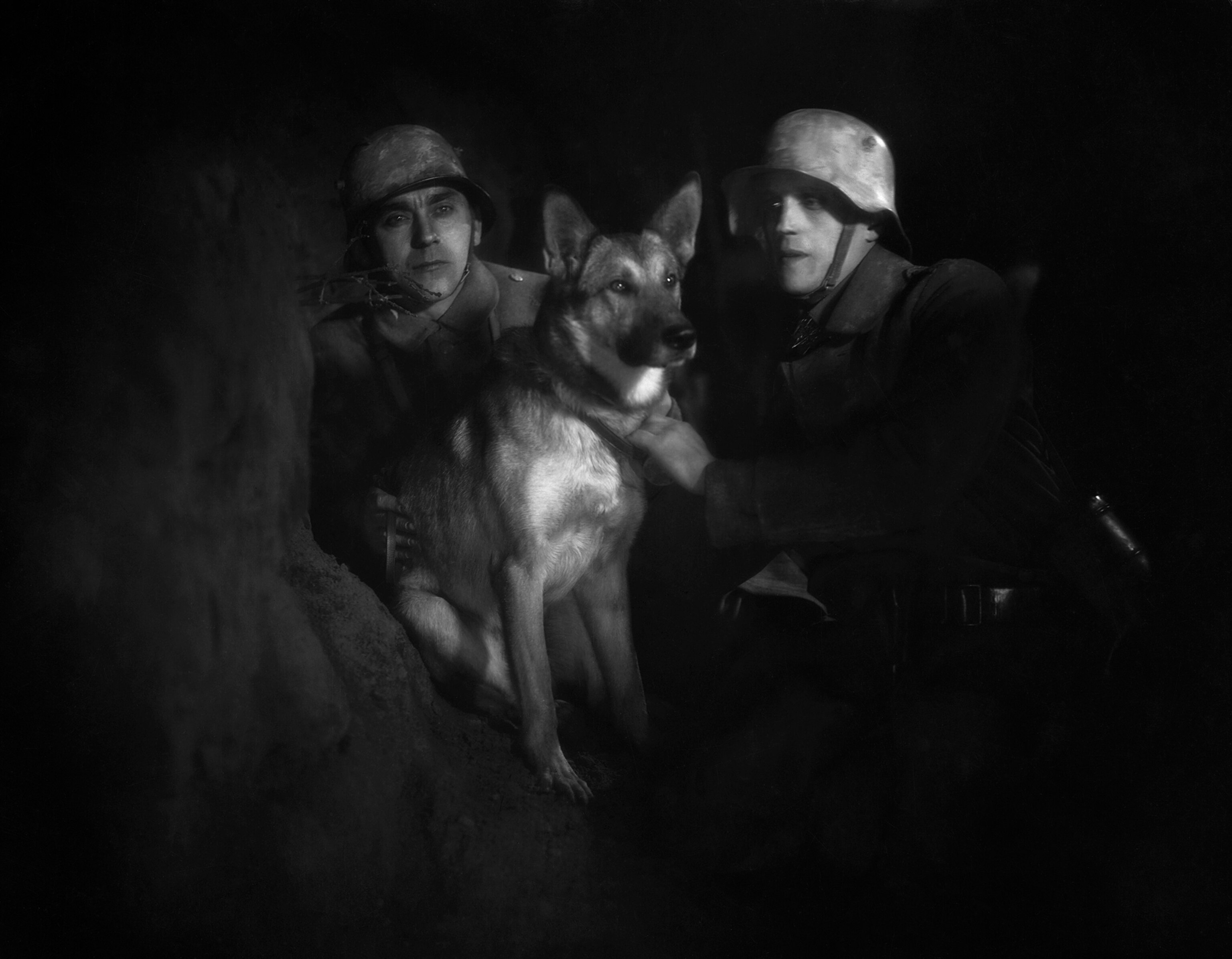 A solider and dog work to find the wounded in poisonous war areas.