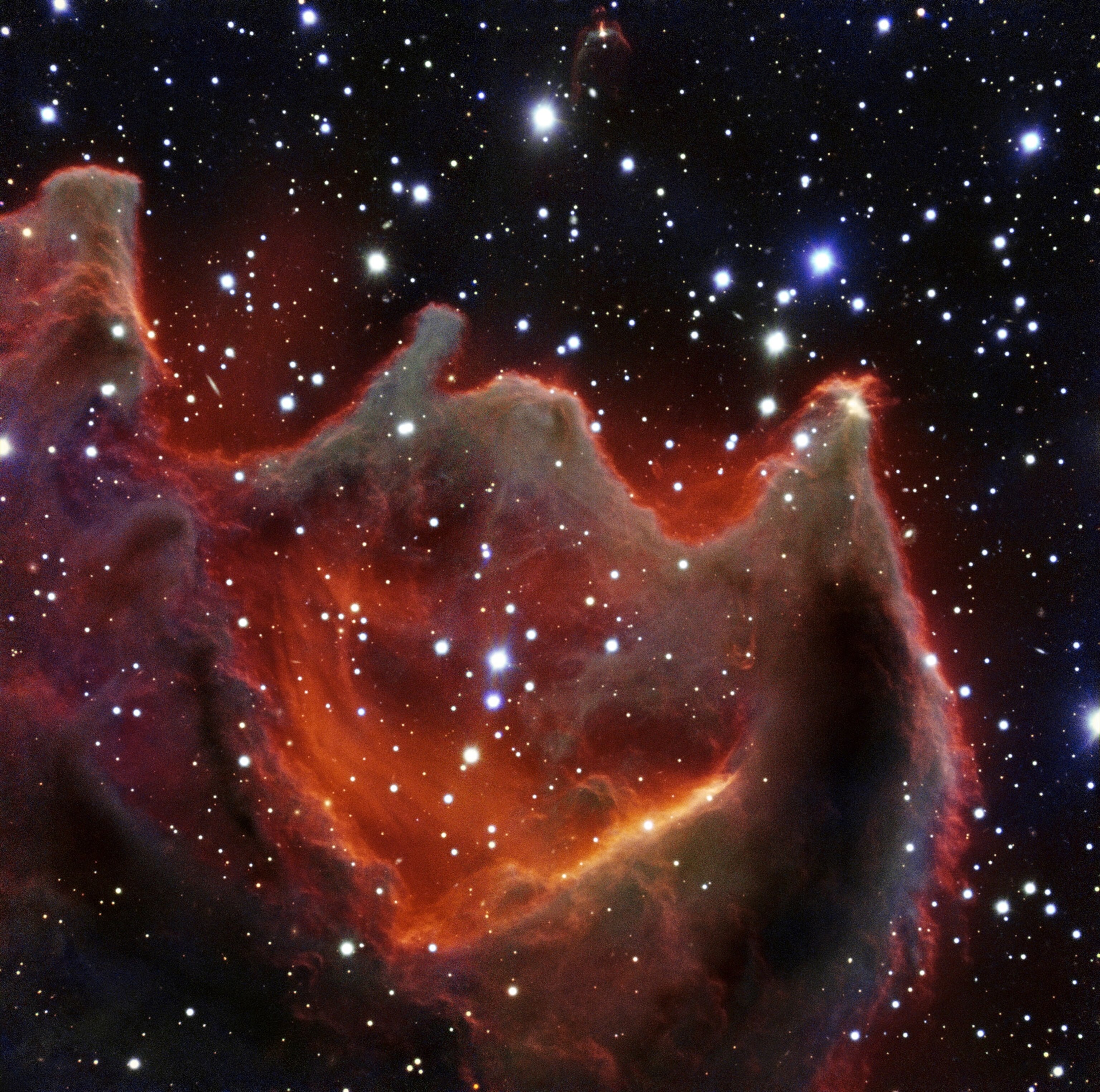 the gaping mouth of a gigantic celestial creature, the cometary globule CG4 glows menacingly in this new image from ESO’s Very Large Telescope.