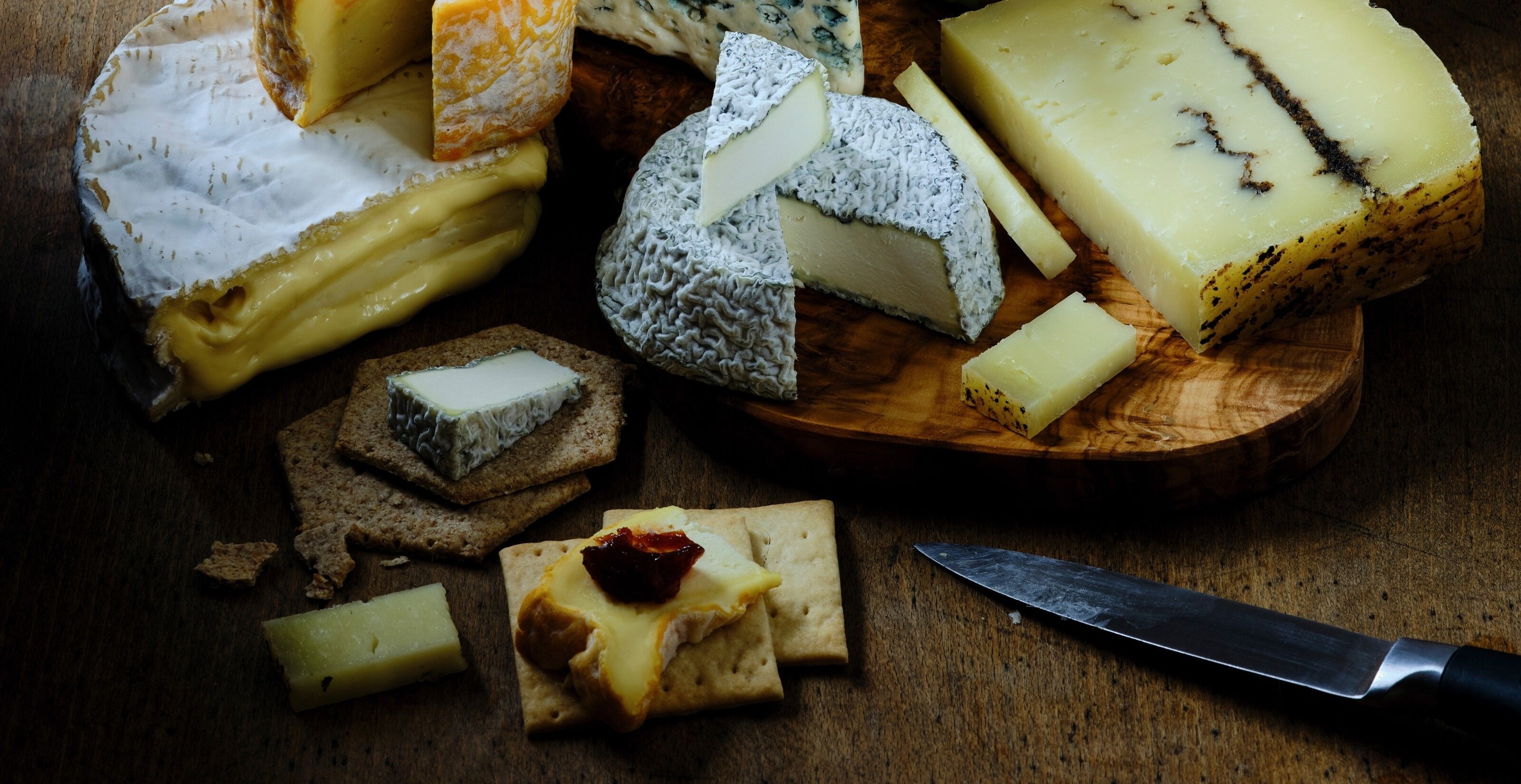 When creating a cheese board, the cheeses should ideally be served simply, alongside plain crackers.