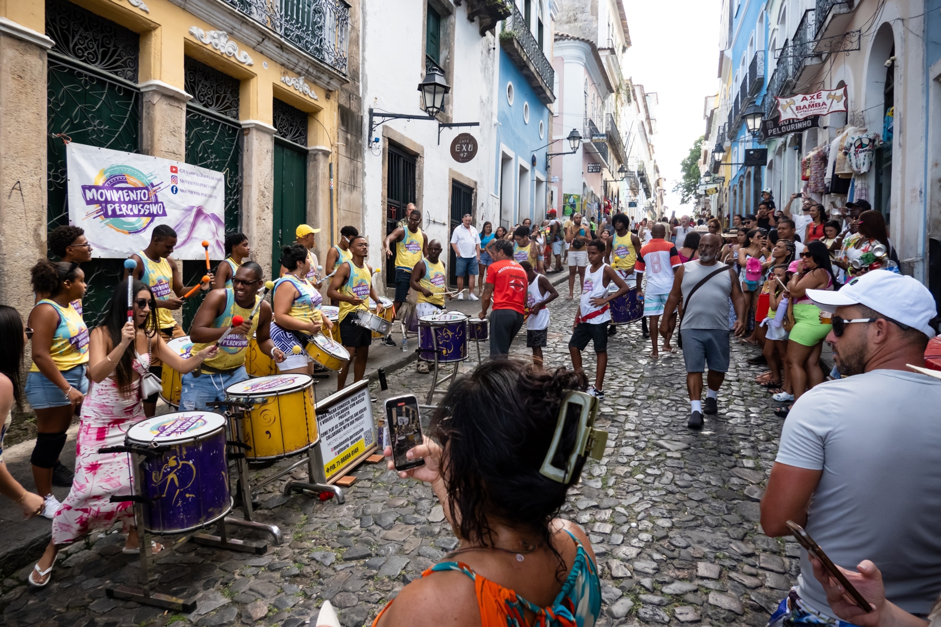 Tourists watch the performance of drum players in the city center of Pelourinho in Salvador, Bahia, Brazil, on February 8, 2025.