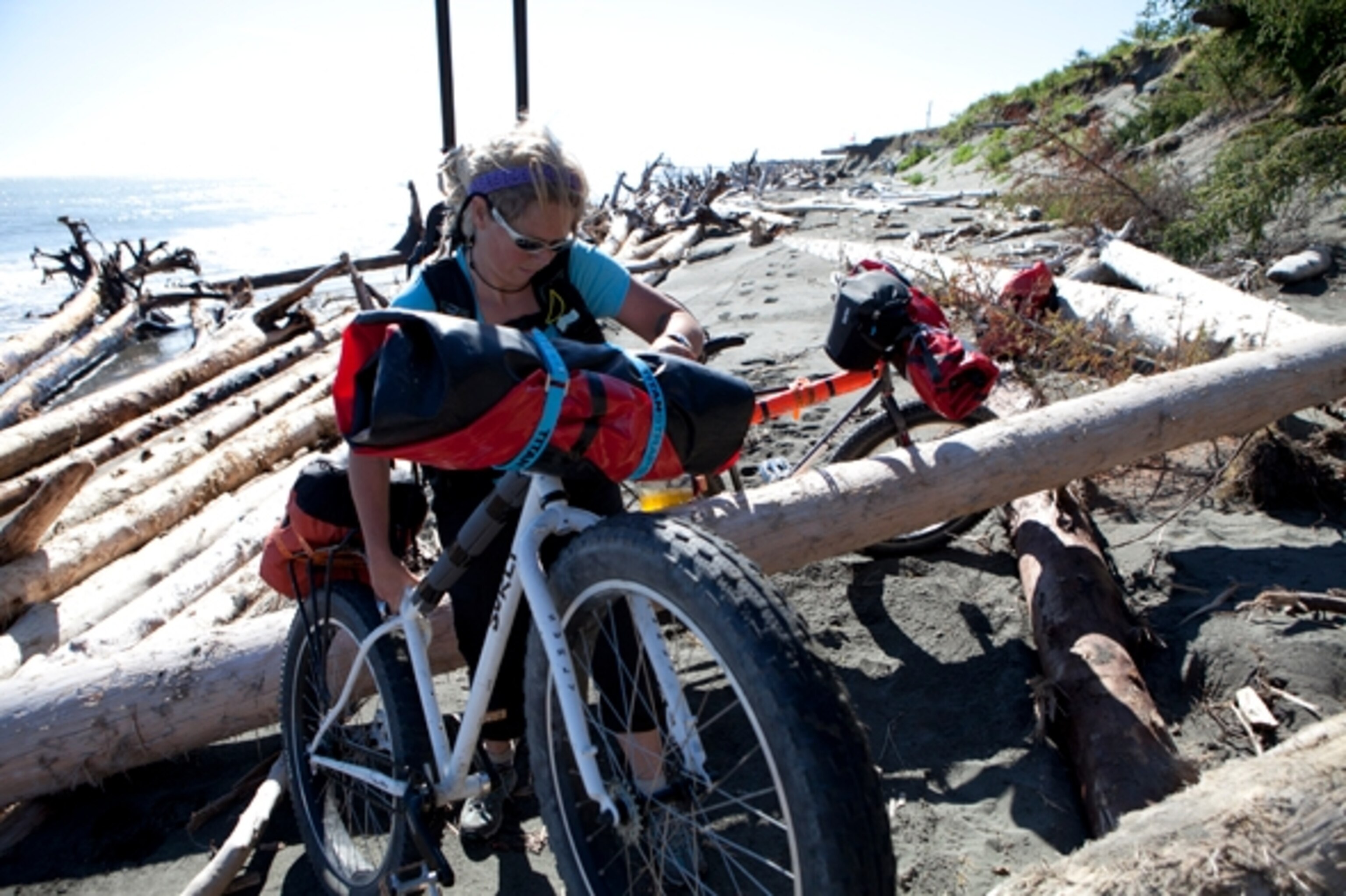 The pedaling came to a halt as we encountered a beach packed with weather-beaten driftwood near Situk Lagoon; Photograph by Cameron Lawson