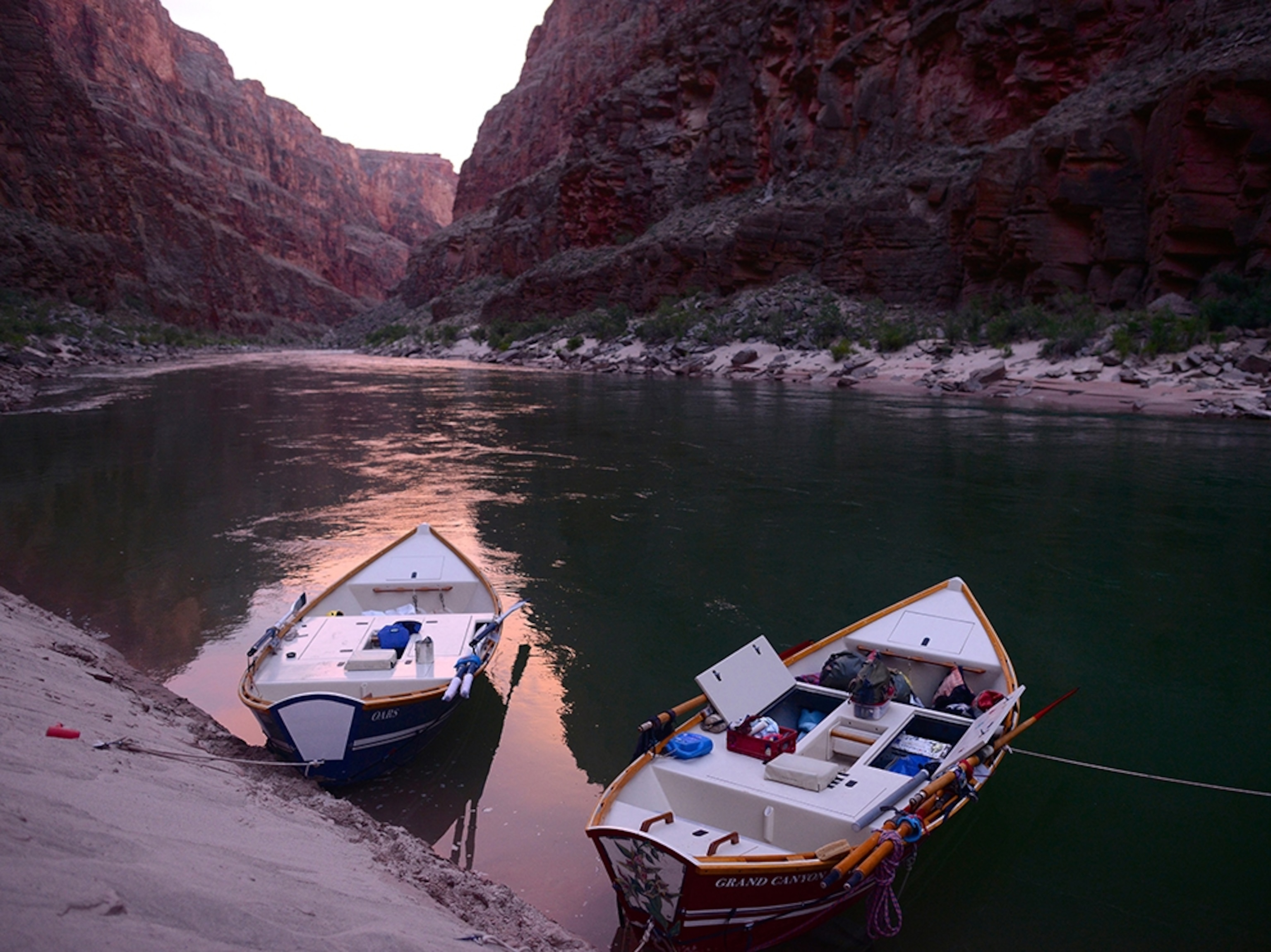 boats on a calm river in the Grand Canyon