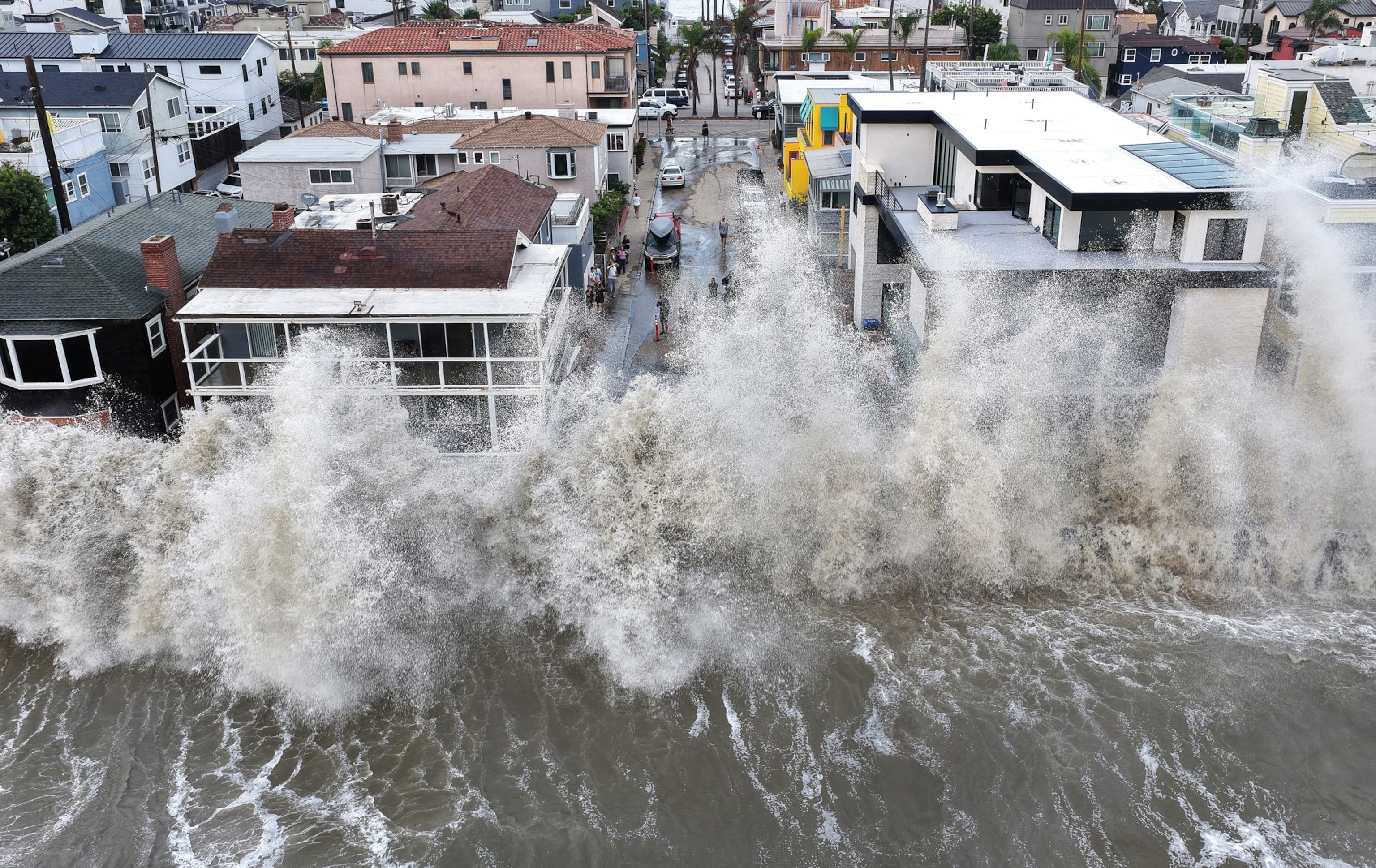 In an aerial view, a Pacific Ocean wave crashes into a seawall protecting beachside homes on September 7, 2026 in Long Beach, California.
