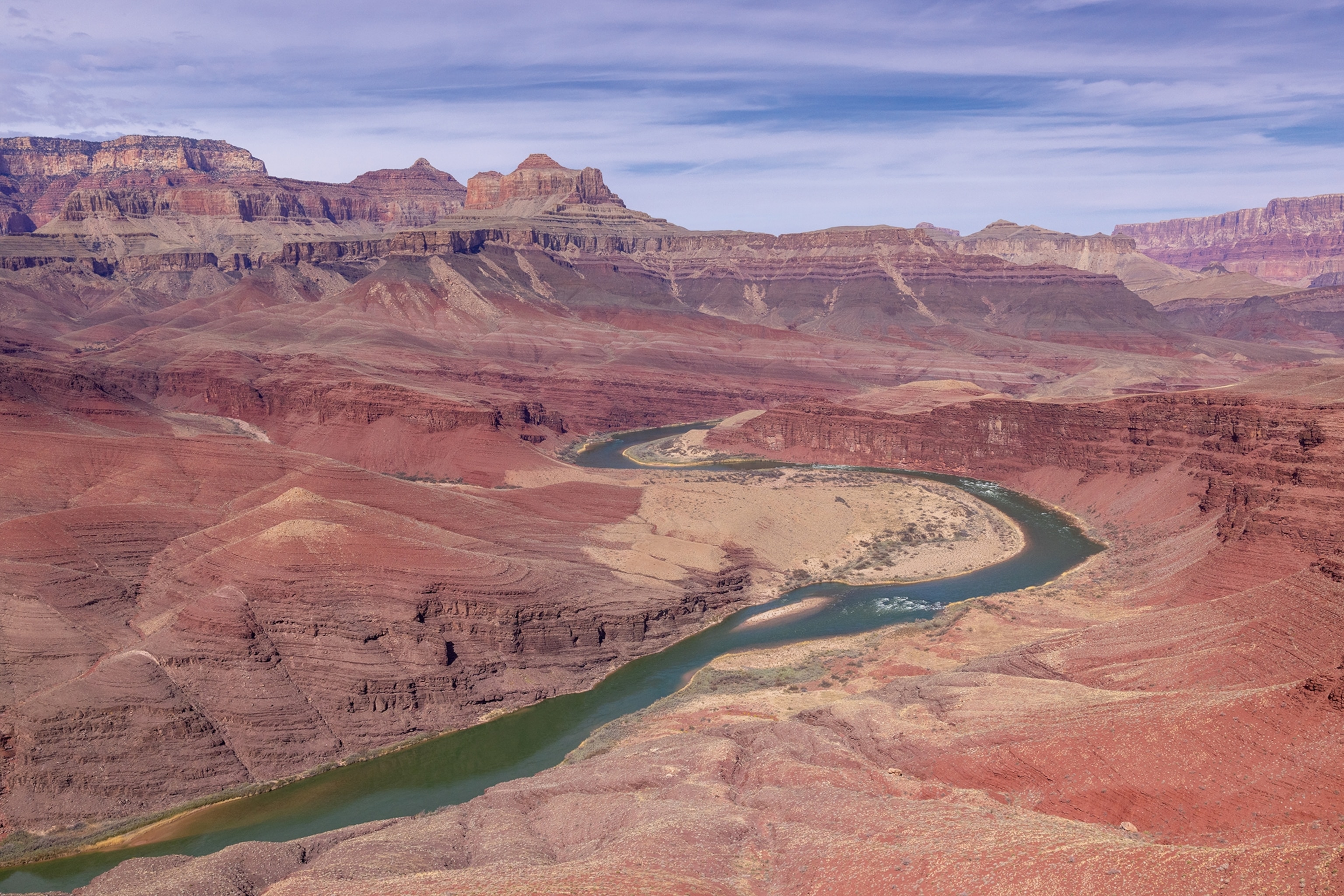 An aerial shot of a river snaking through a canyon.
