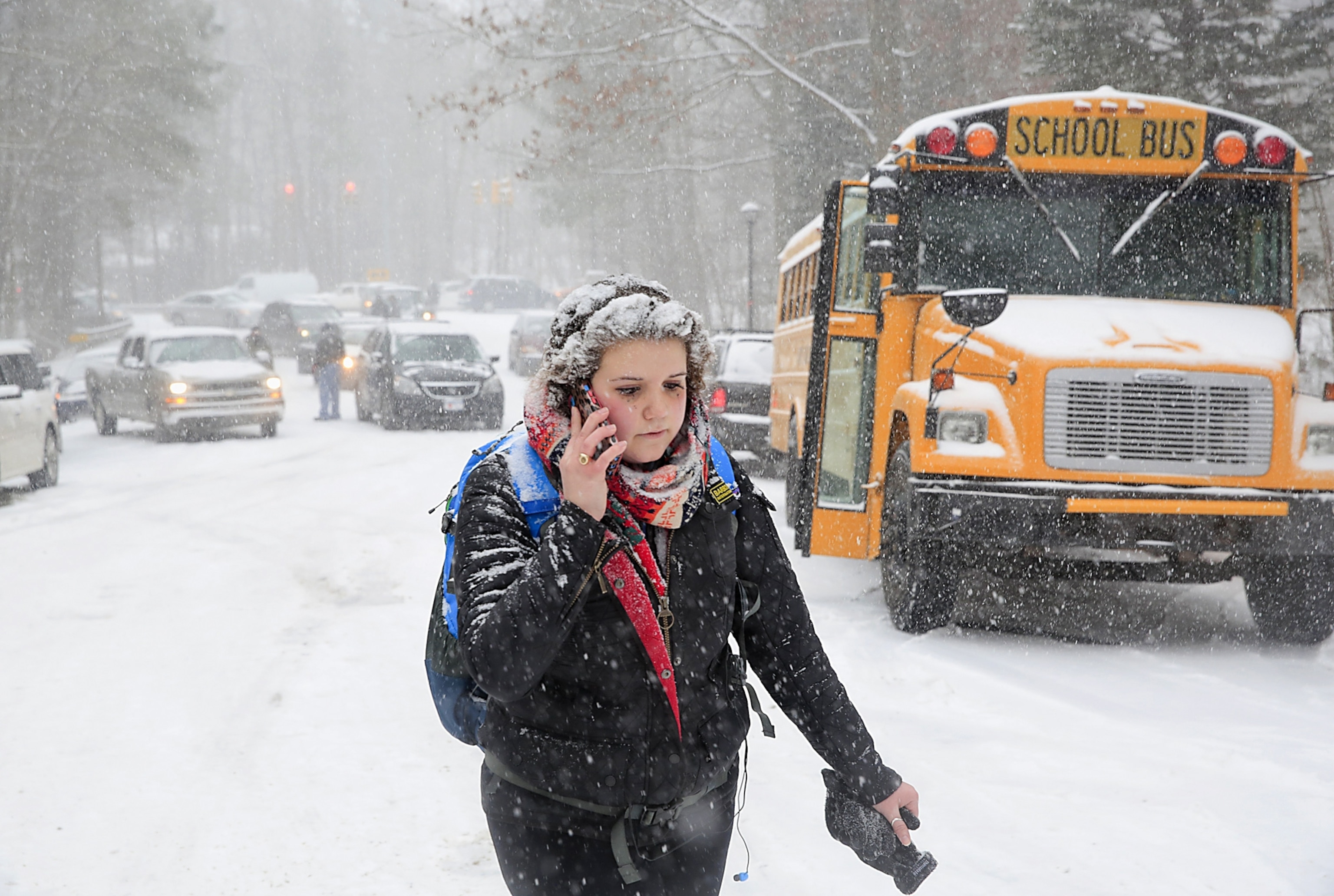 A man braces his umbrella while walking through the snow in NY City.