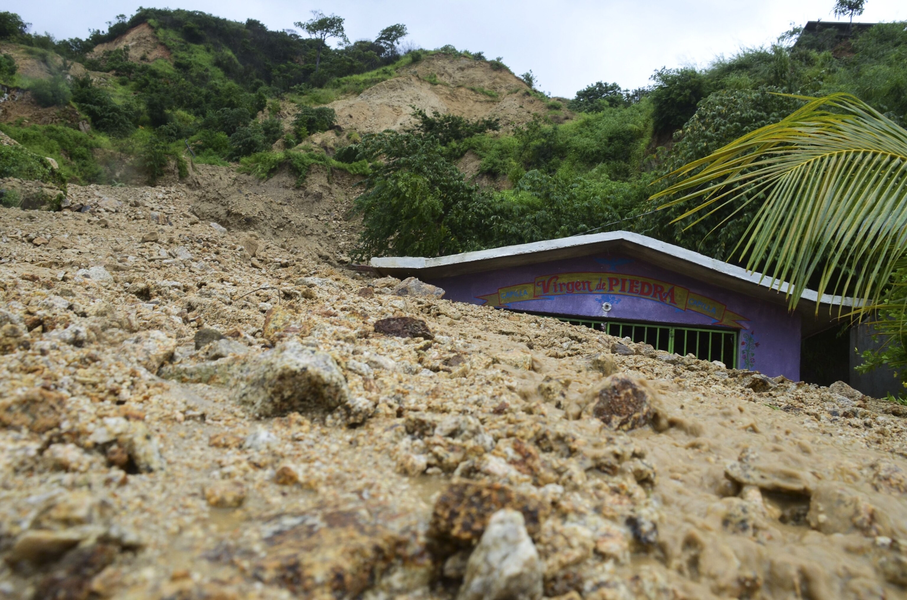 a chapel swallowed by rocks and mud on the outskirts of Acapulco, Mexico