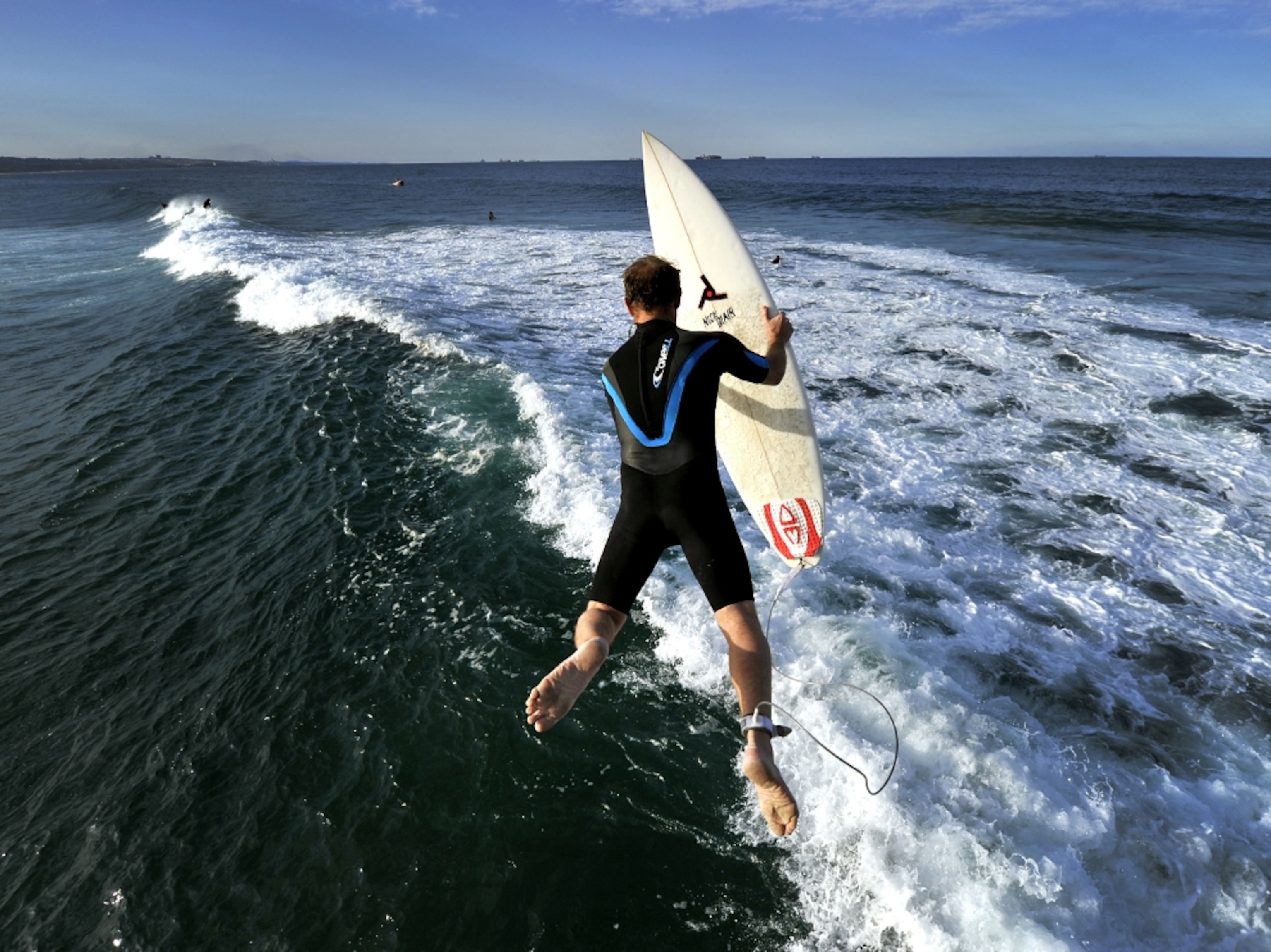 A surfer diving in the water near Durban