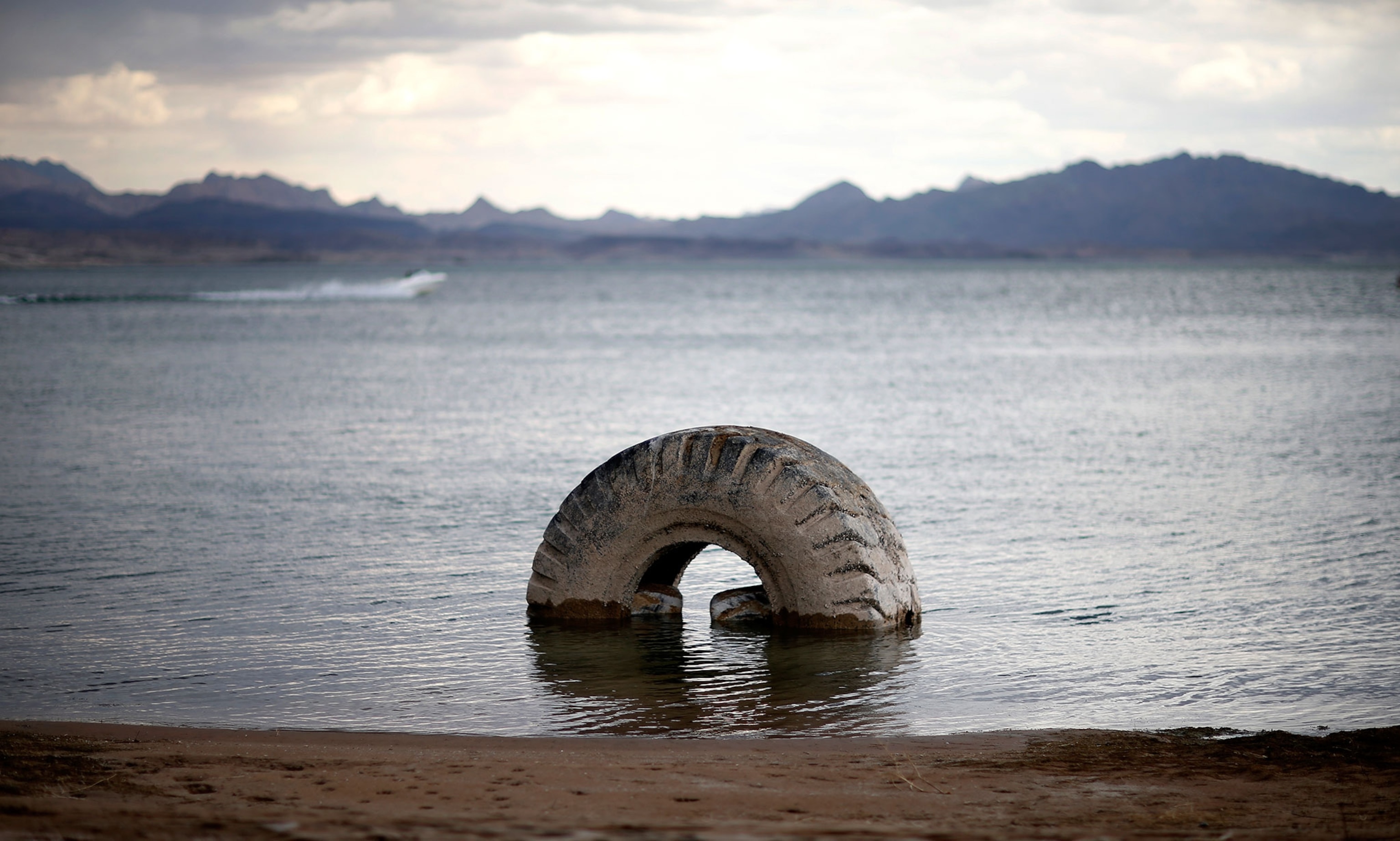 a partially submerged tire poking up from Lake Mead in Nevada