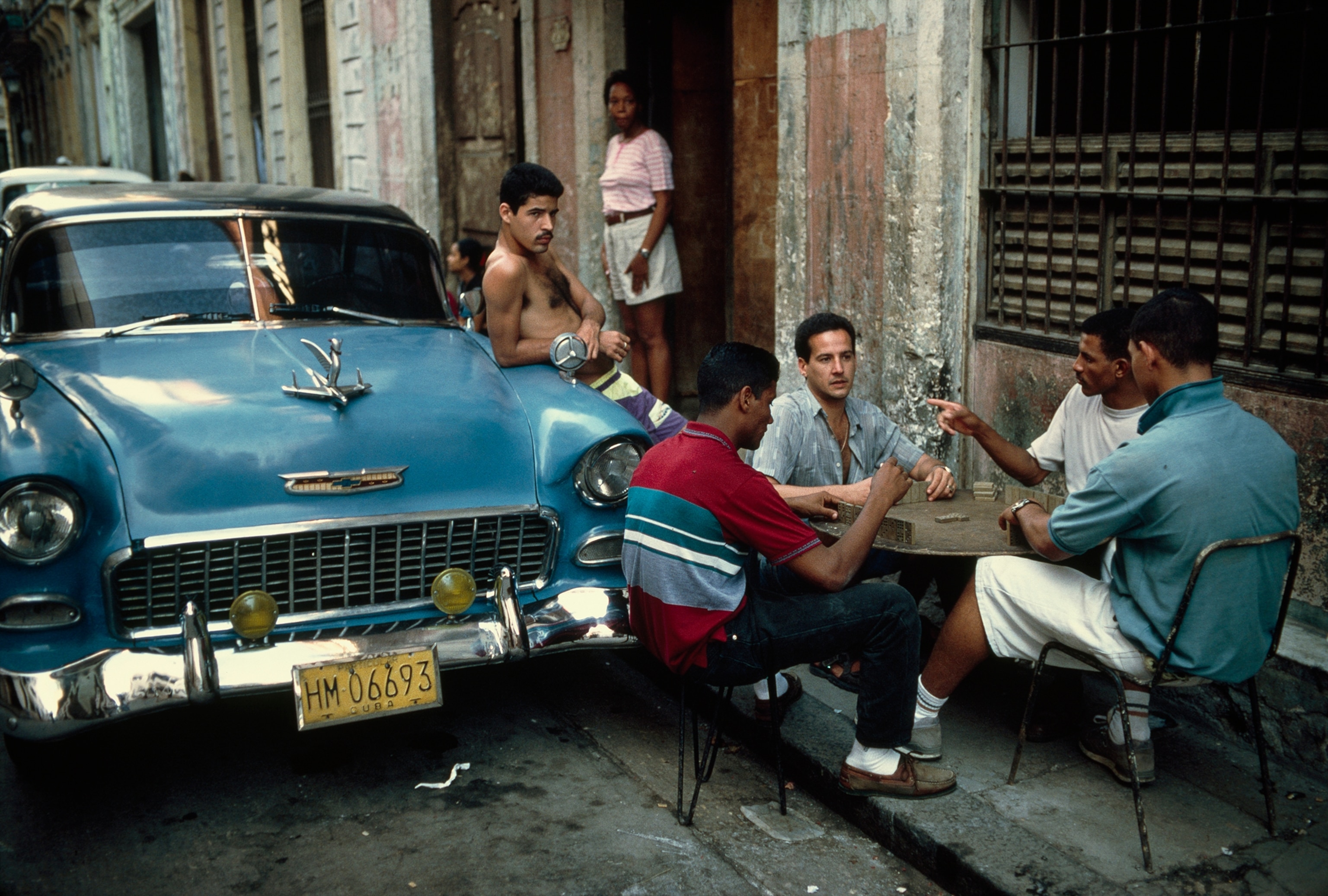Cubans near a classic car