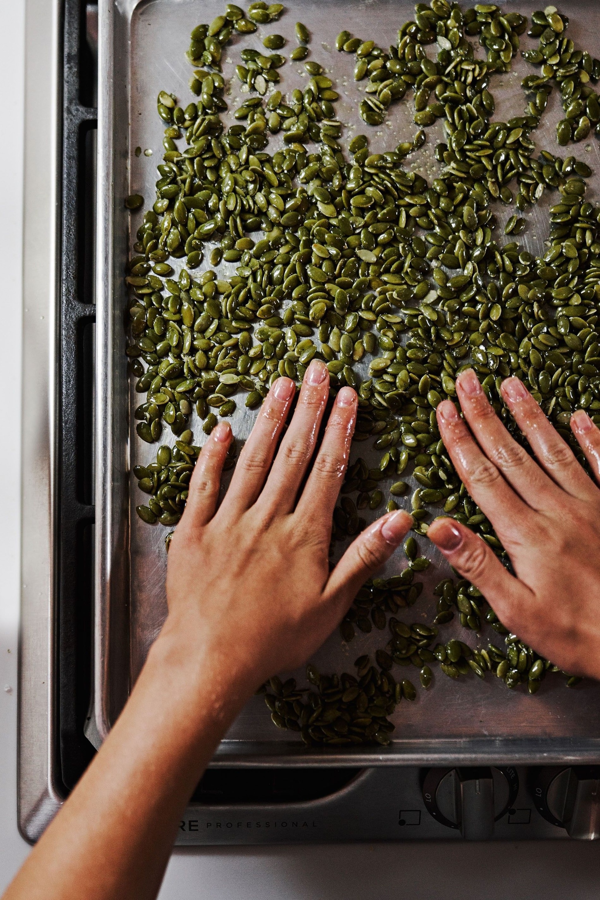 Preparing roasted pumpkin seeds for the salad.
