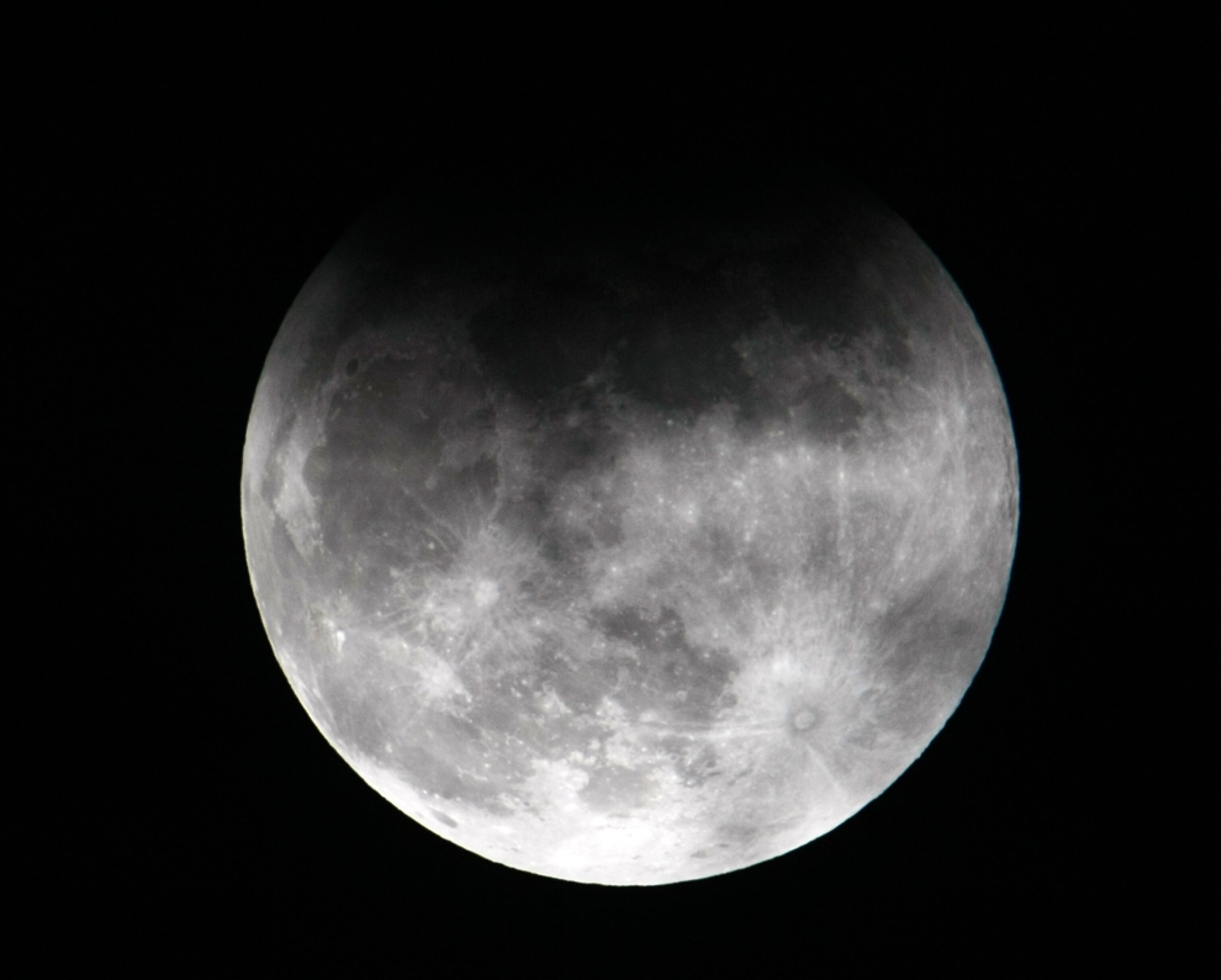 A 2010 lunar eclipse picture shows the Earth's shadow partially falling on the moon in the Philippines.
