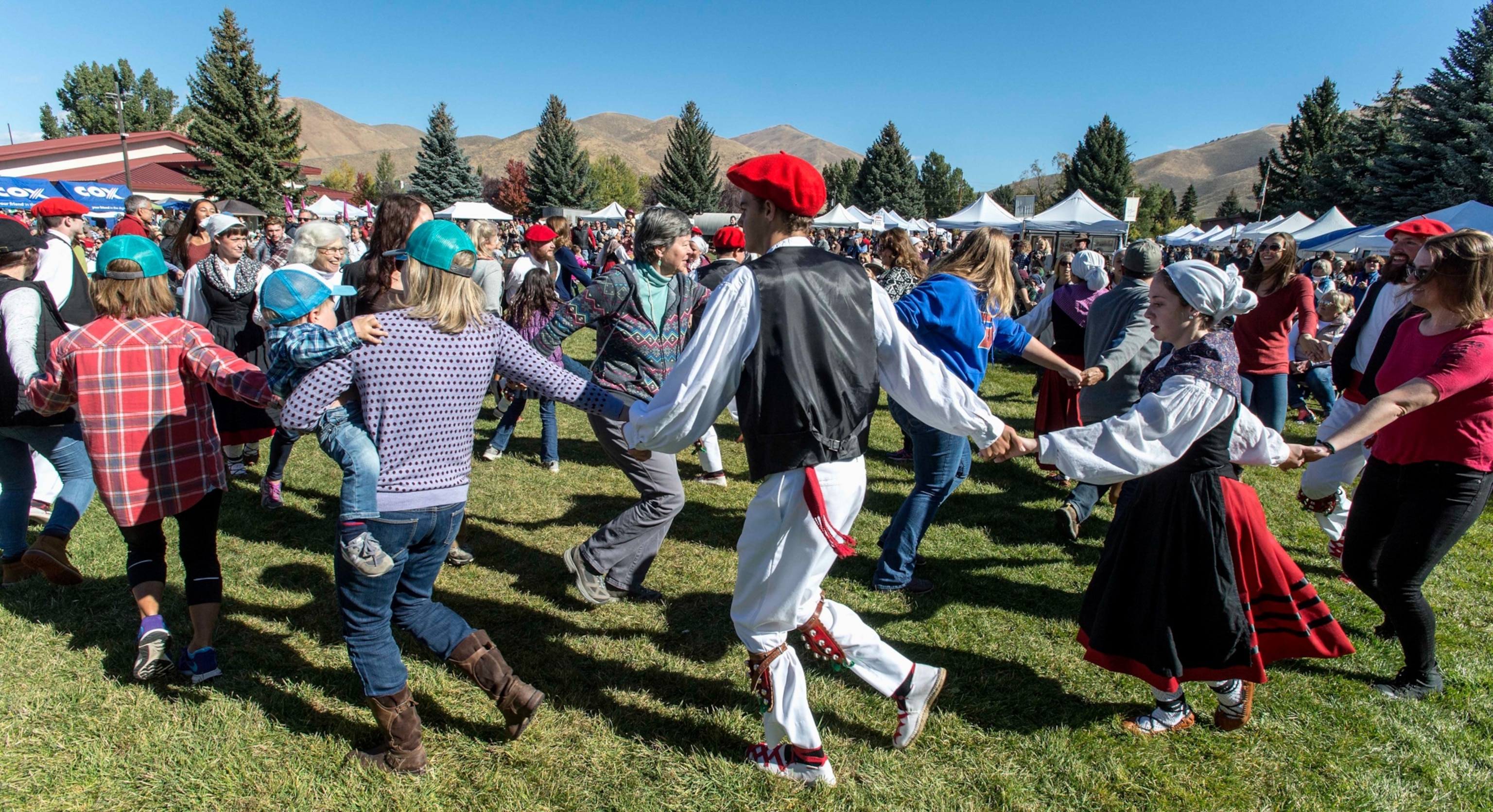 A group of people dancing in a circle.