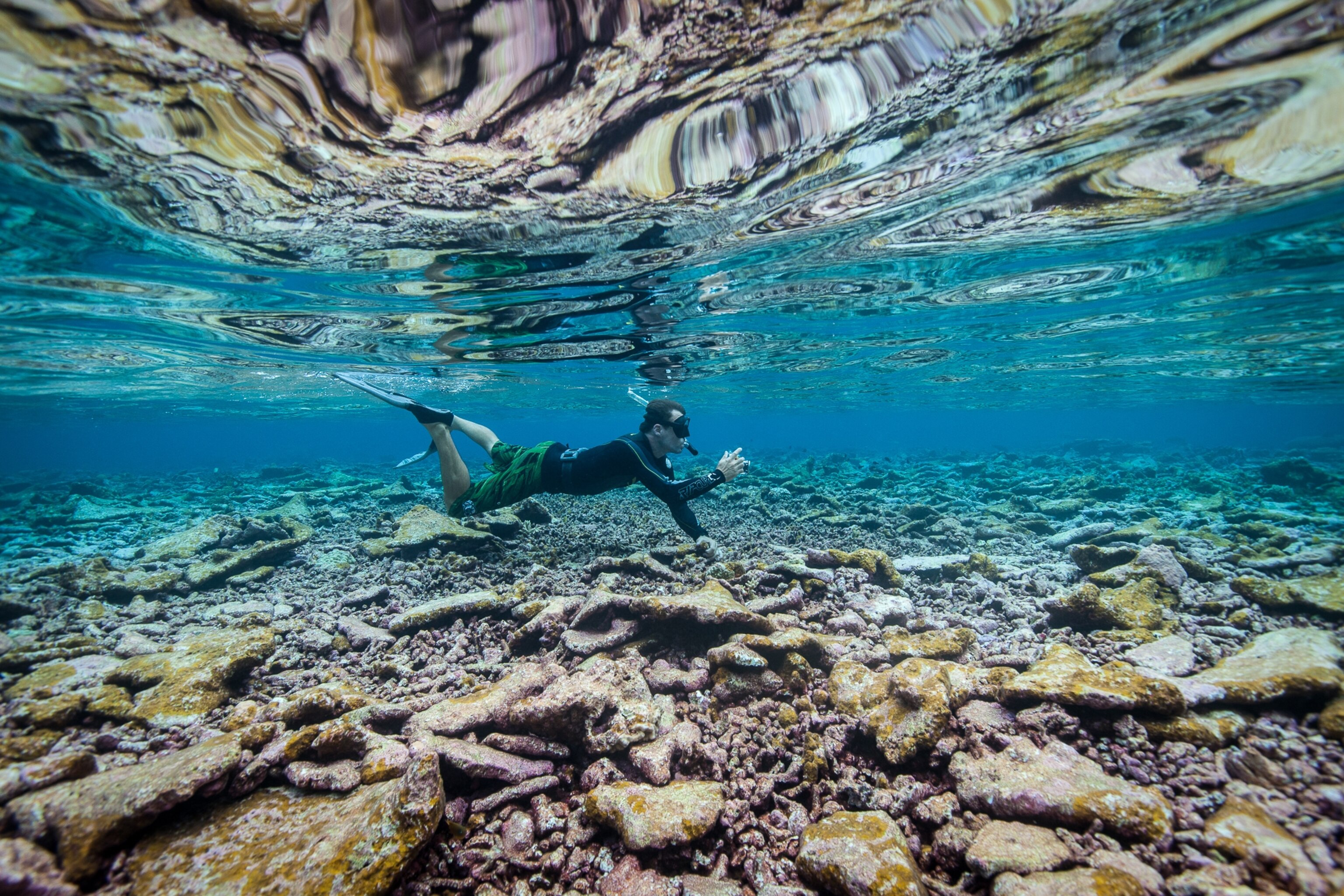 Kydd Pollock, Science Specialist with The Nature Conservancy, aims his camera across the reef crest near