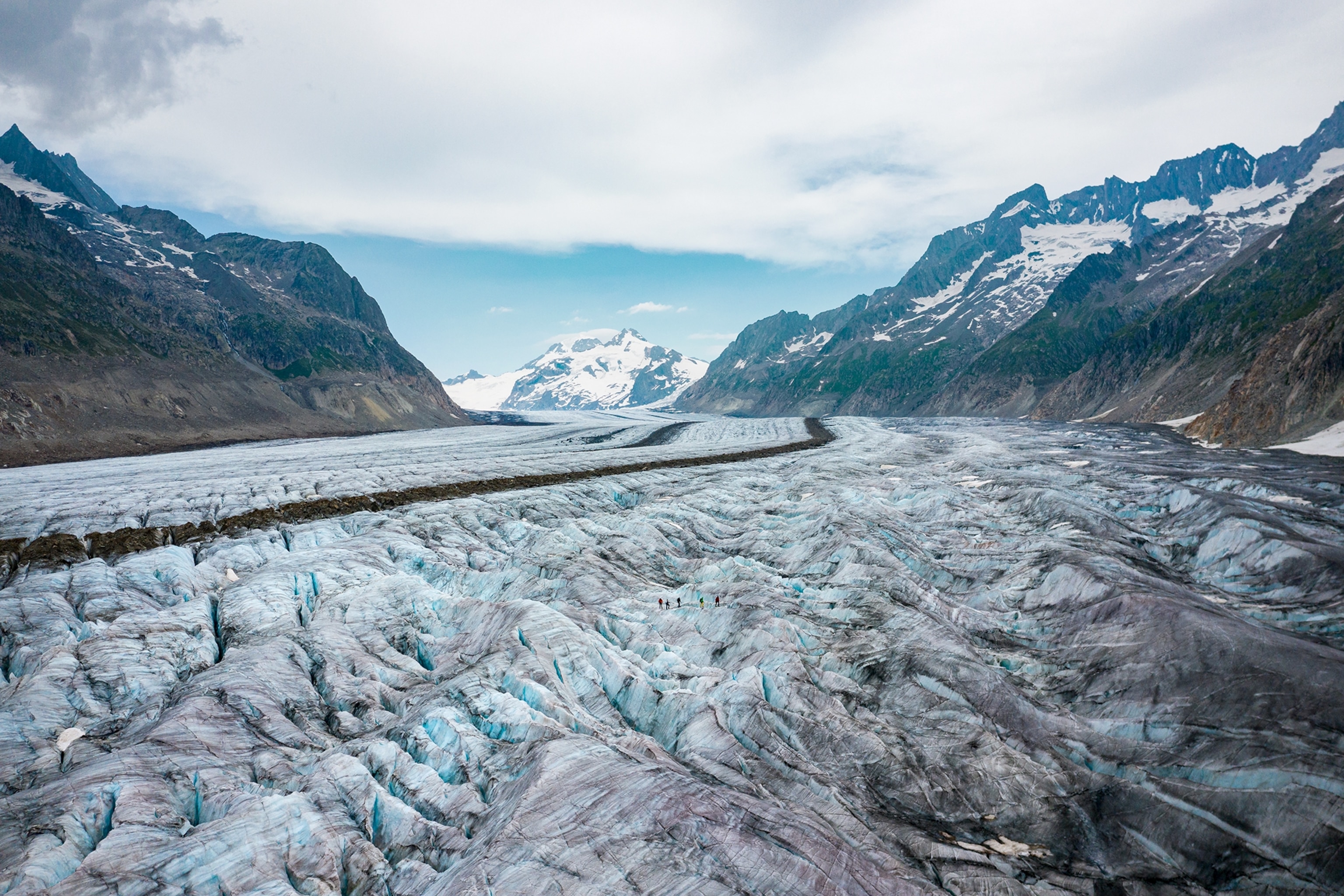 The long ice flow of the Aletsch Glacier is surrounded by snowy mountain peaks.