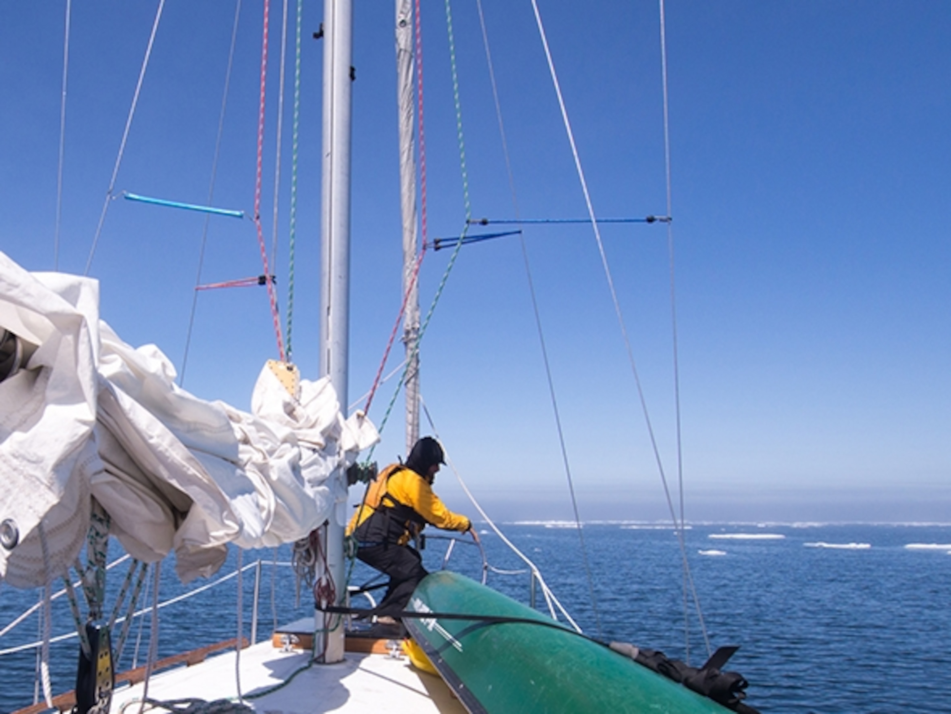 Dave Freeman scans the water for chunks of ice in there path as they approach the maze of ice near Whitefish Point; Photograph by Amy Freeman