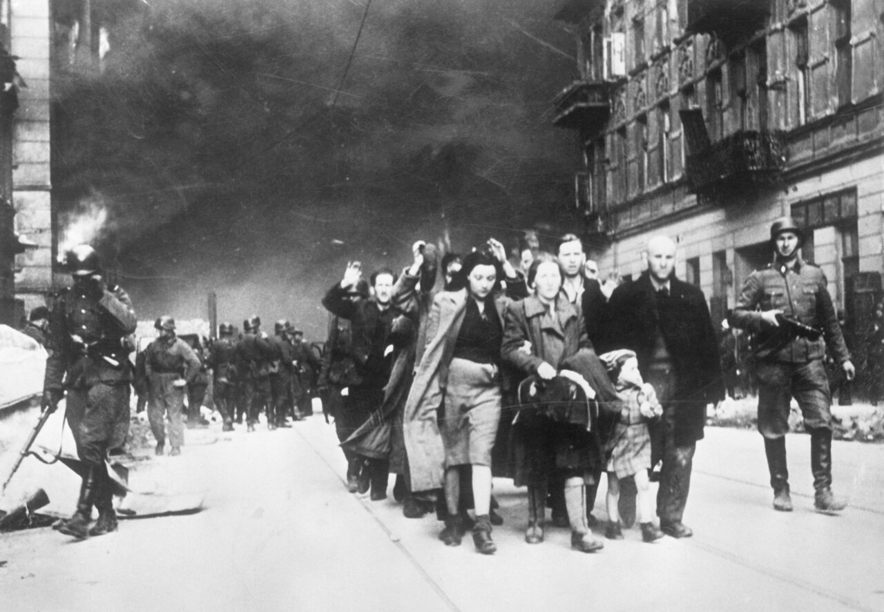 Photo of crowd of people fleeing through a street