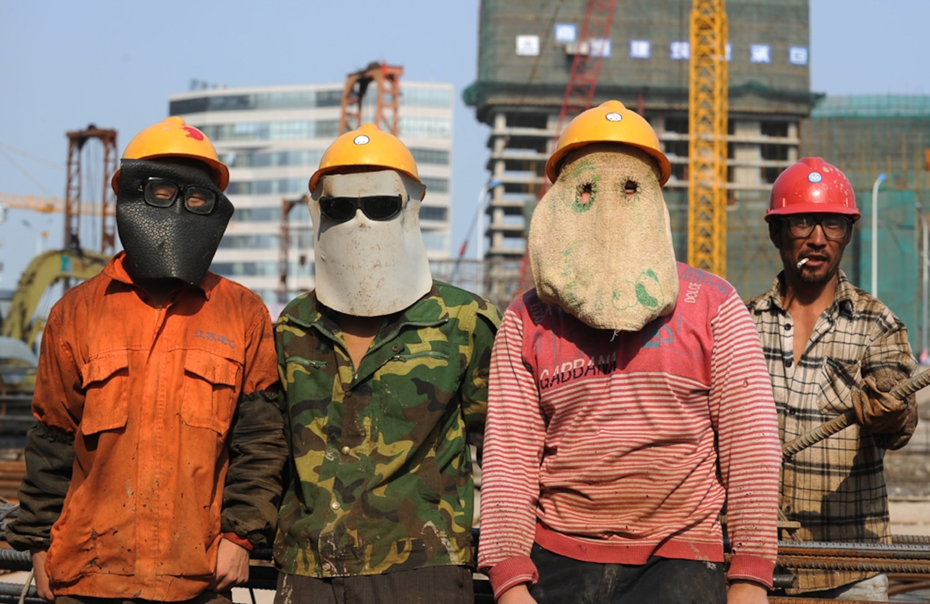 Construction workers picture: workers in China wearing masks -- for best pictures of August photo gallery