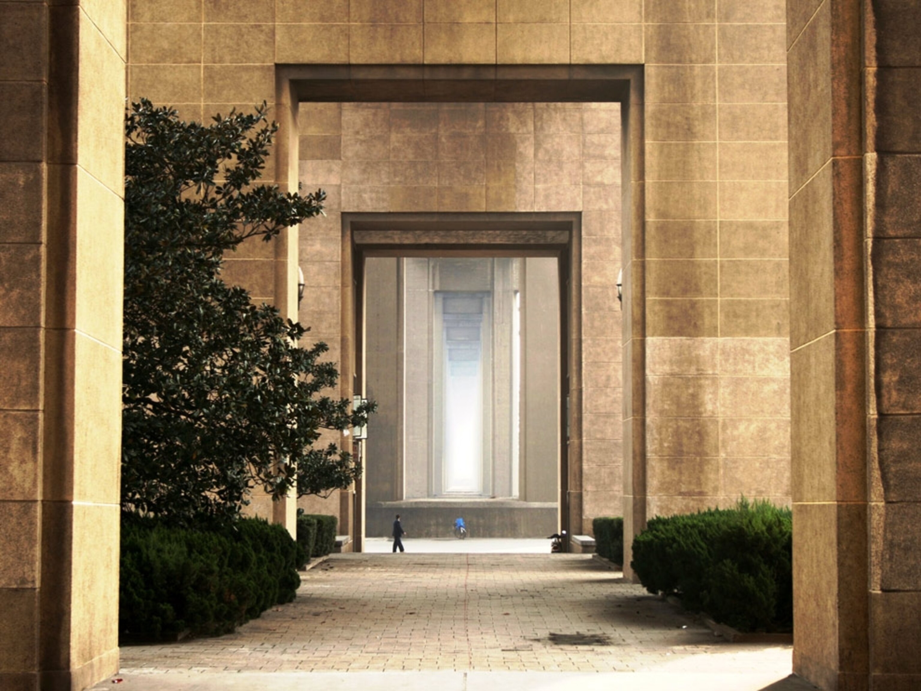 Man walking beneath a bridge