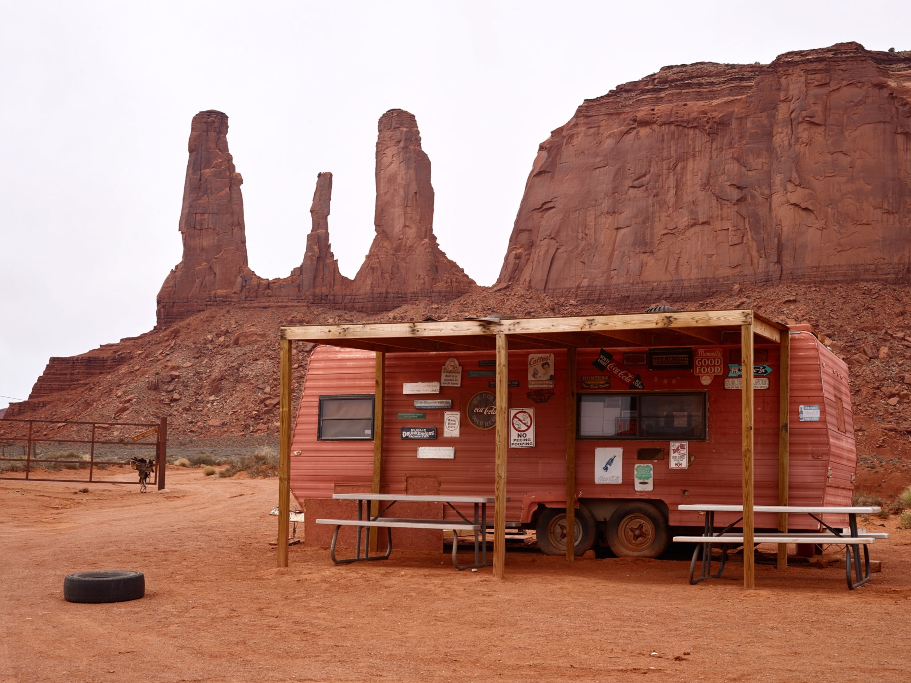 a rust-colored food trailer in the red desert of Mounument Valley