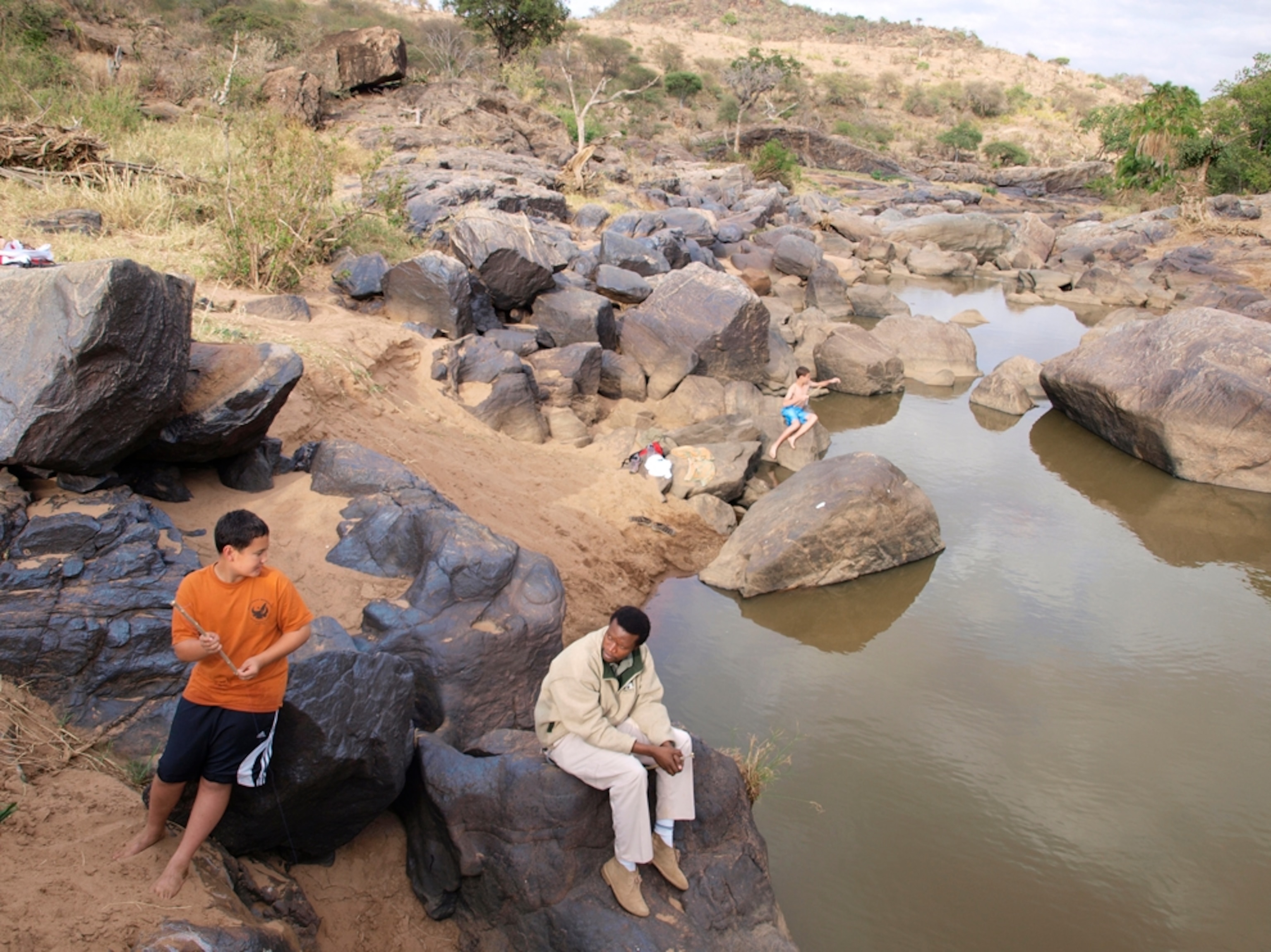 Teenage boys fishing Ewaso Ng'iro River, Kenya, Africa