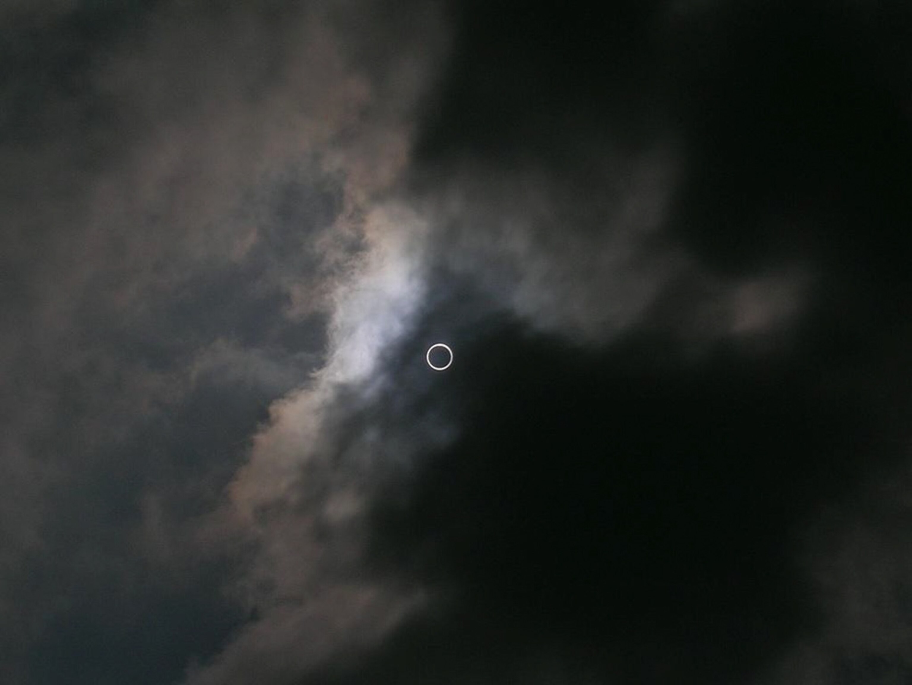 Picture of an annular eclipse making a ring of light among dark clouds--a winner in the Astronomy Photographer of the Year space-pictures competition