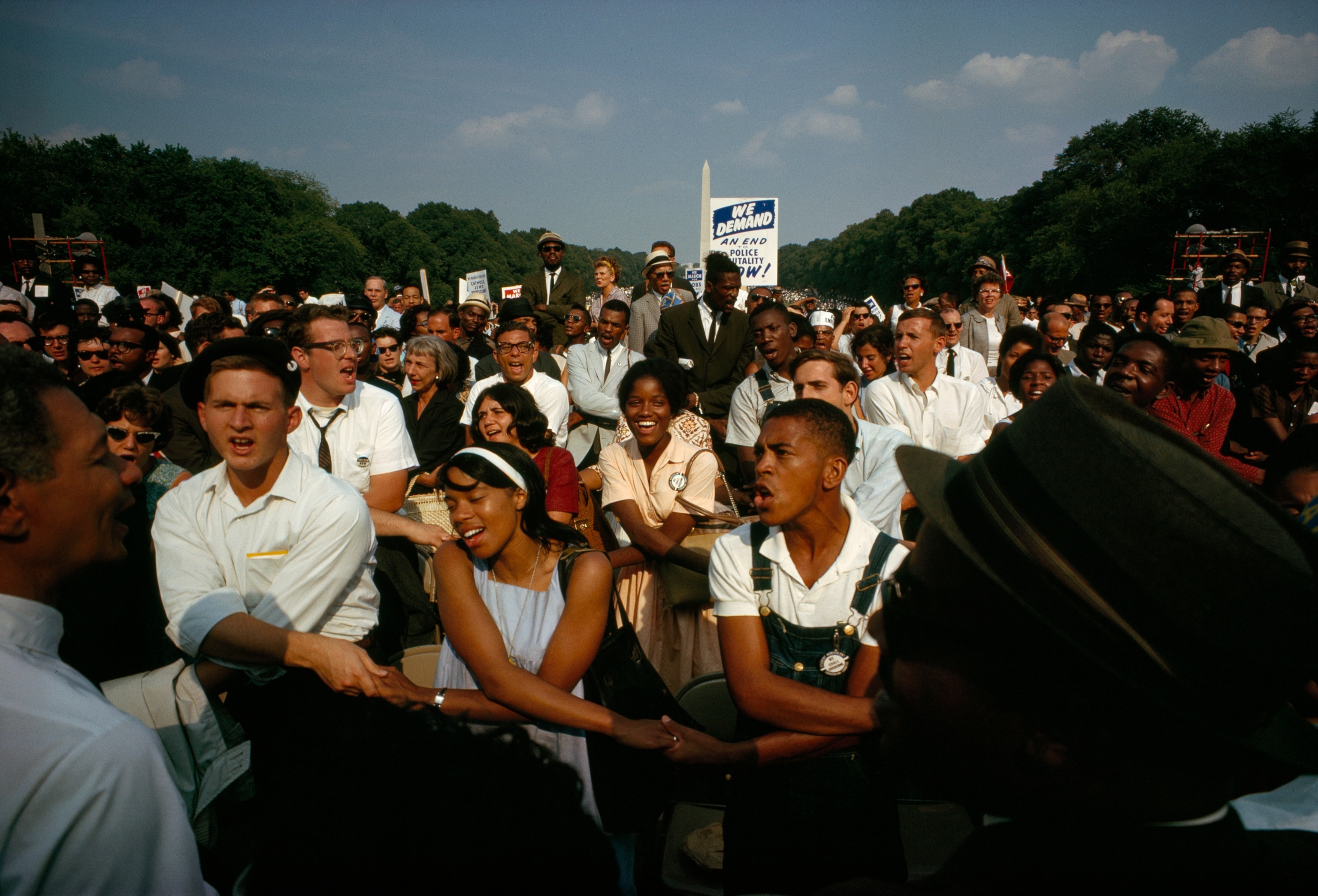 A crowd of people holding hands and singing during the "March on Washington." The march, which took place on August 28, 1963, saw more than a quarter million particpants and is where Dr. Martin Luther King, Jr. gave his historic "I Have a Dream" speech.