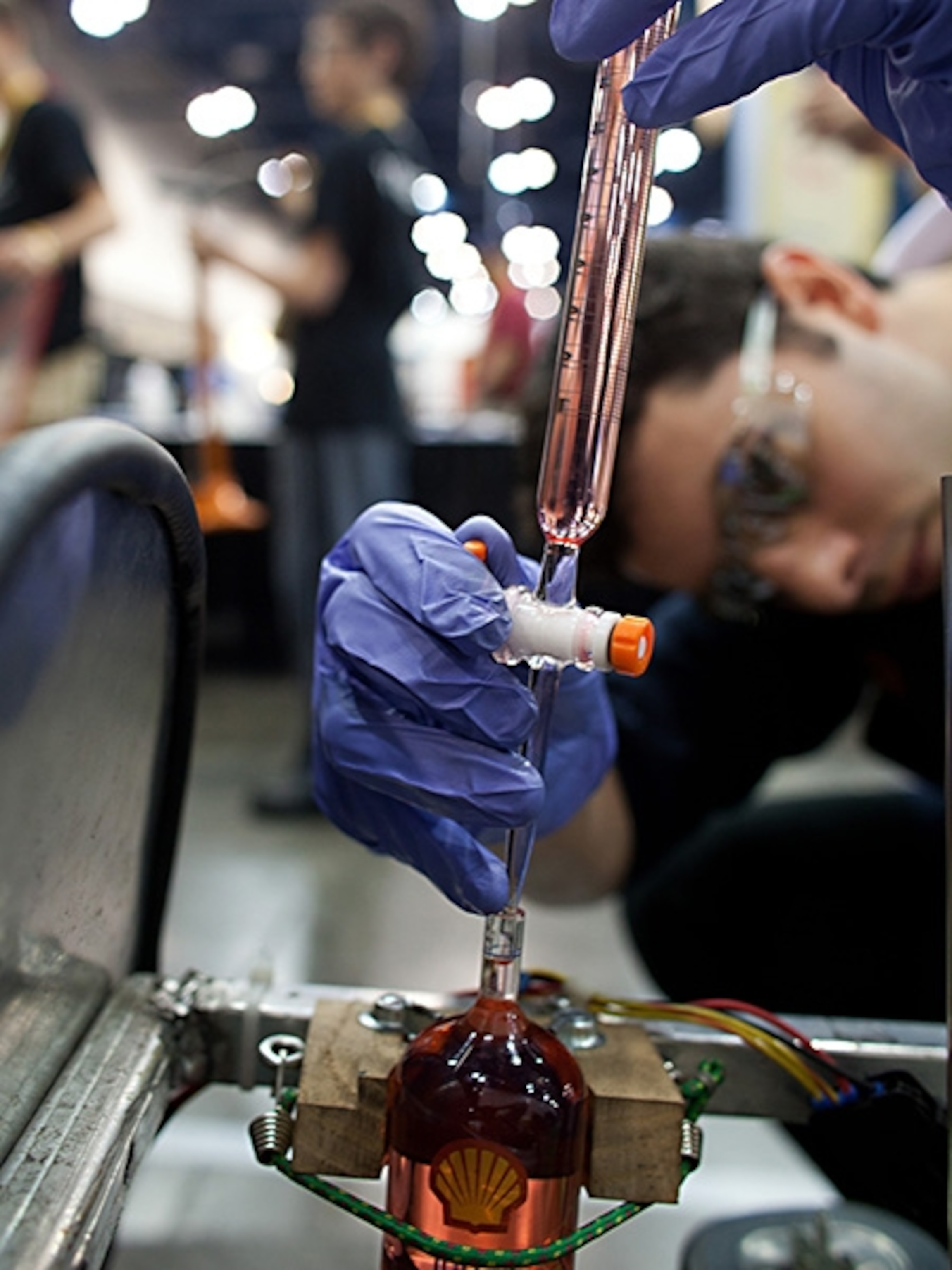 Guy Lovett of Shell carefully measures 150 ml of gasoline from a graduated cylinder.