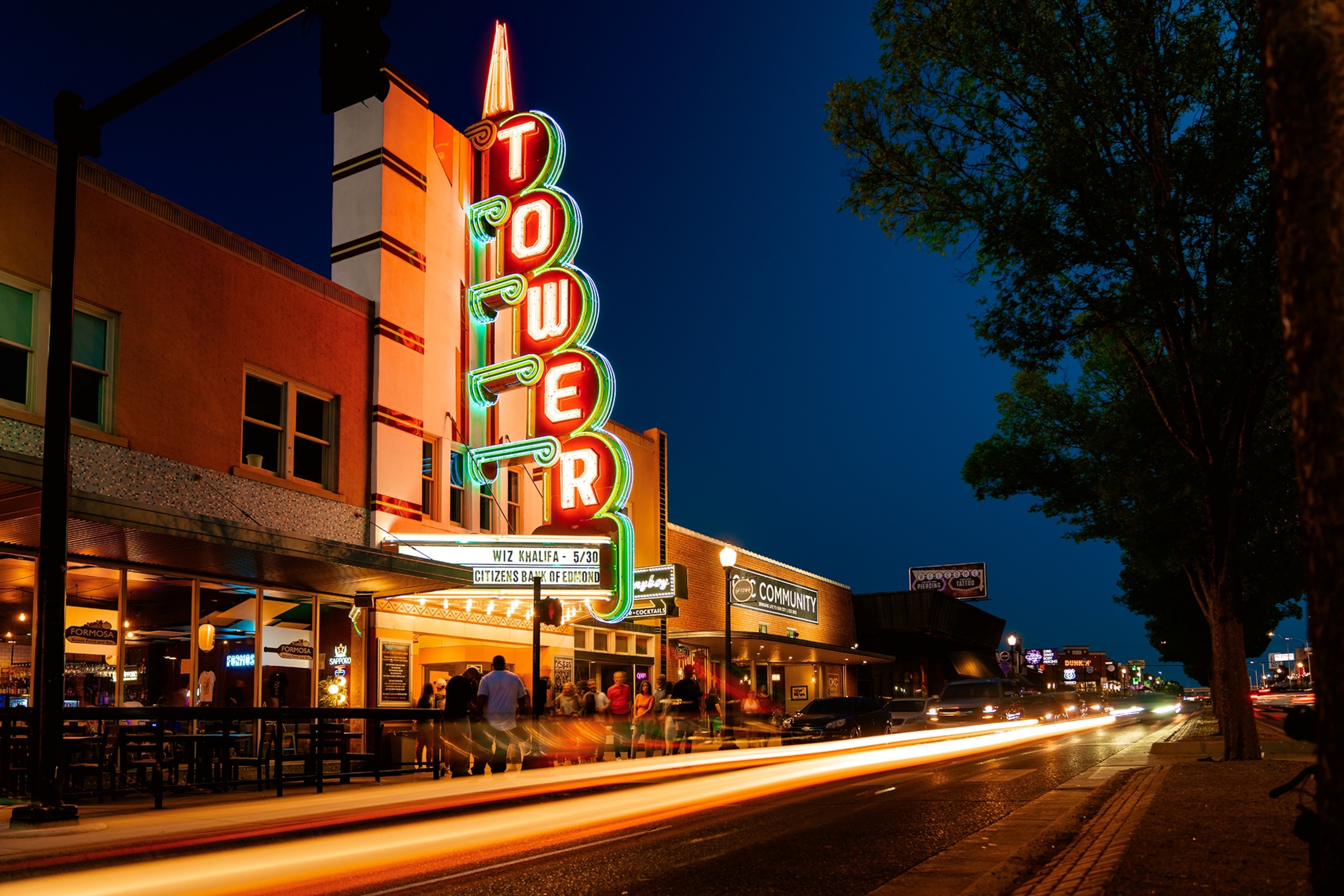 The colourful neon 'Tower' sign in front of the Tower Theater is lit up at night.