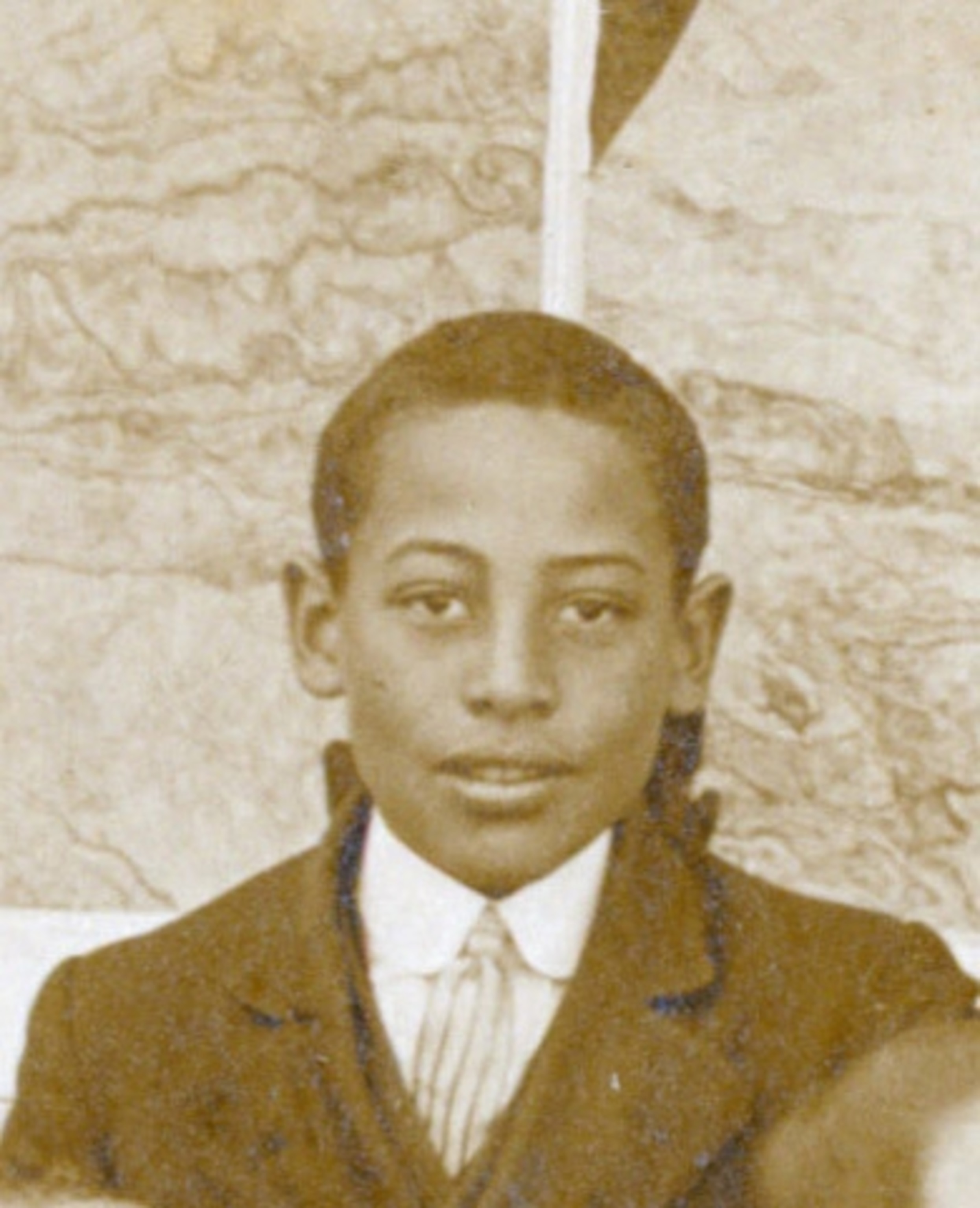 A black and white portrait of a young boy