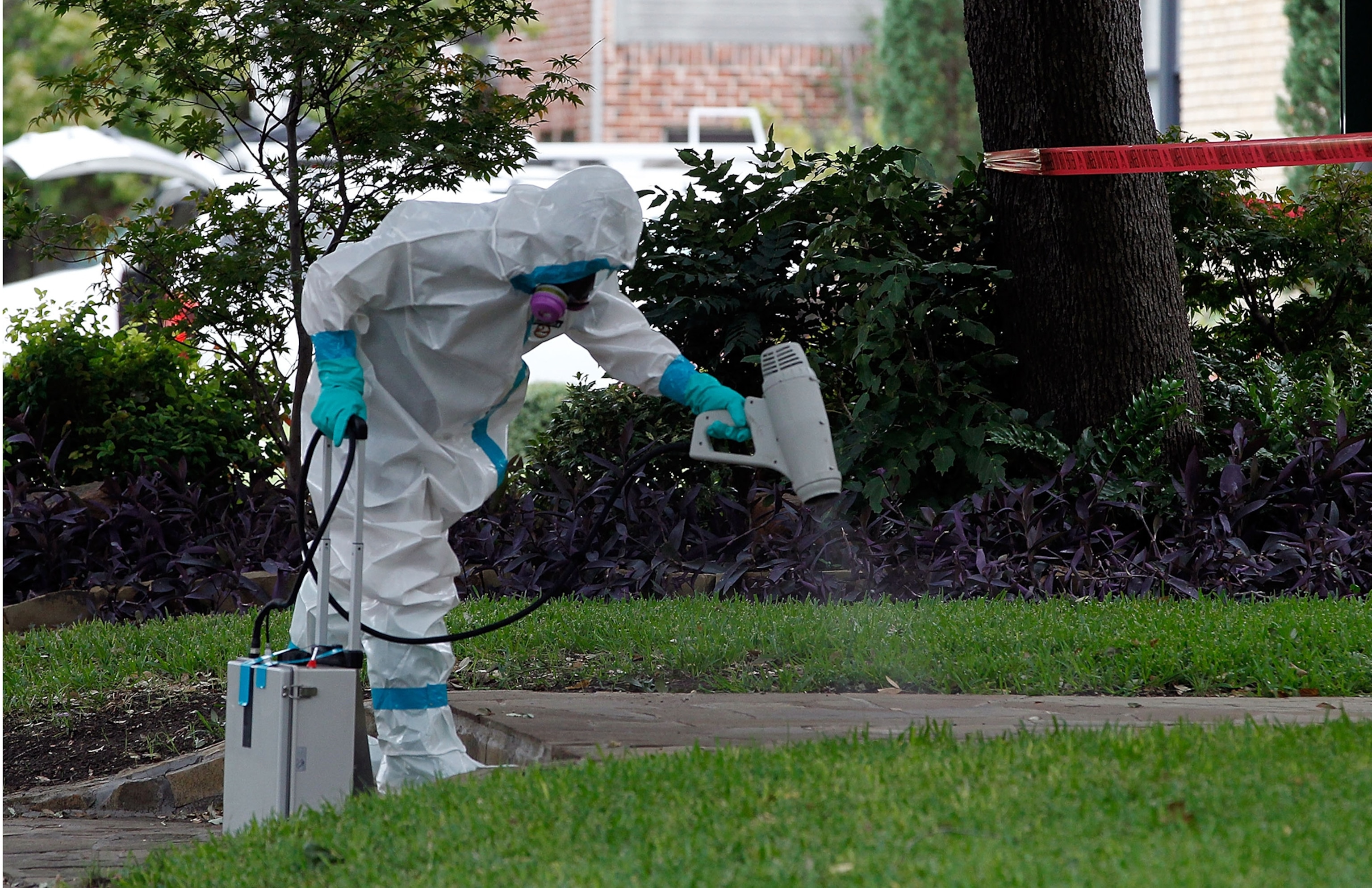 a professor holding a vial of experimental Ebola vaccine.